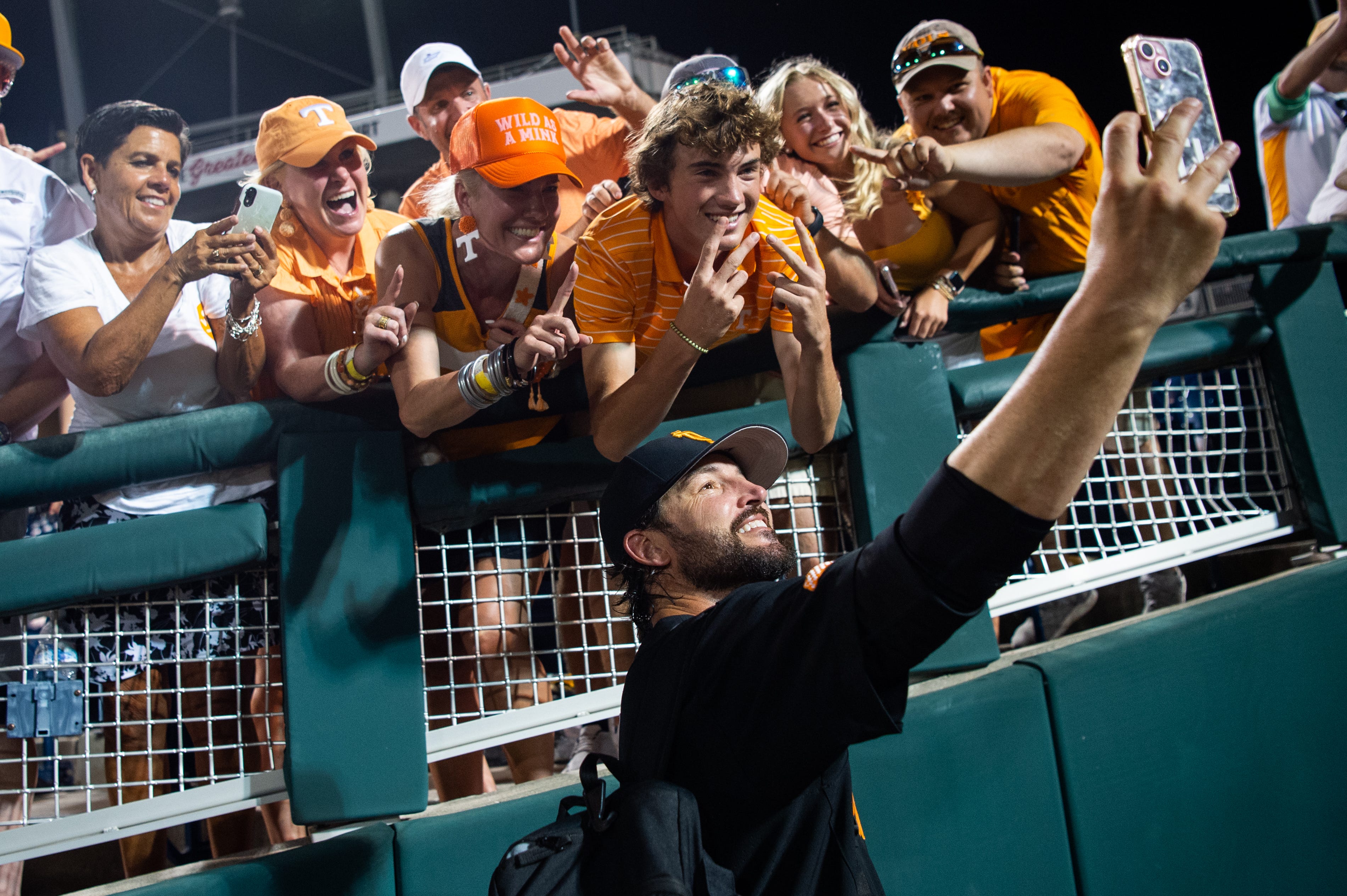 Tennessee head coach Tony Vitello takes a selfie with fans after game three of the NCAA College World Series finals between Tennessee and Texas A&M at Charles Schwab Field in Omaha, Neb., on Monday, June 24, 2024.