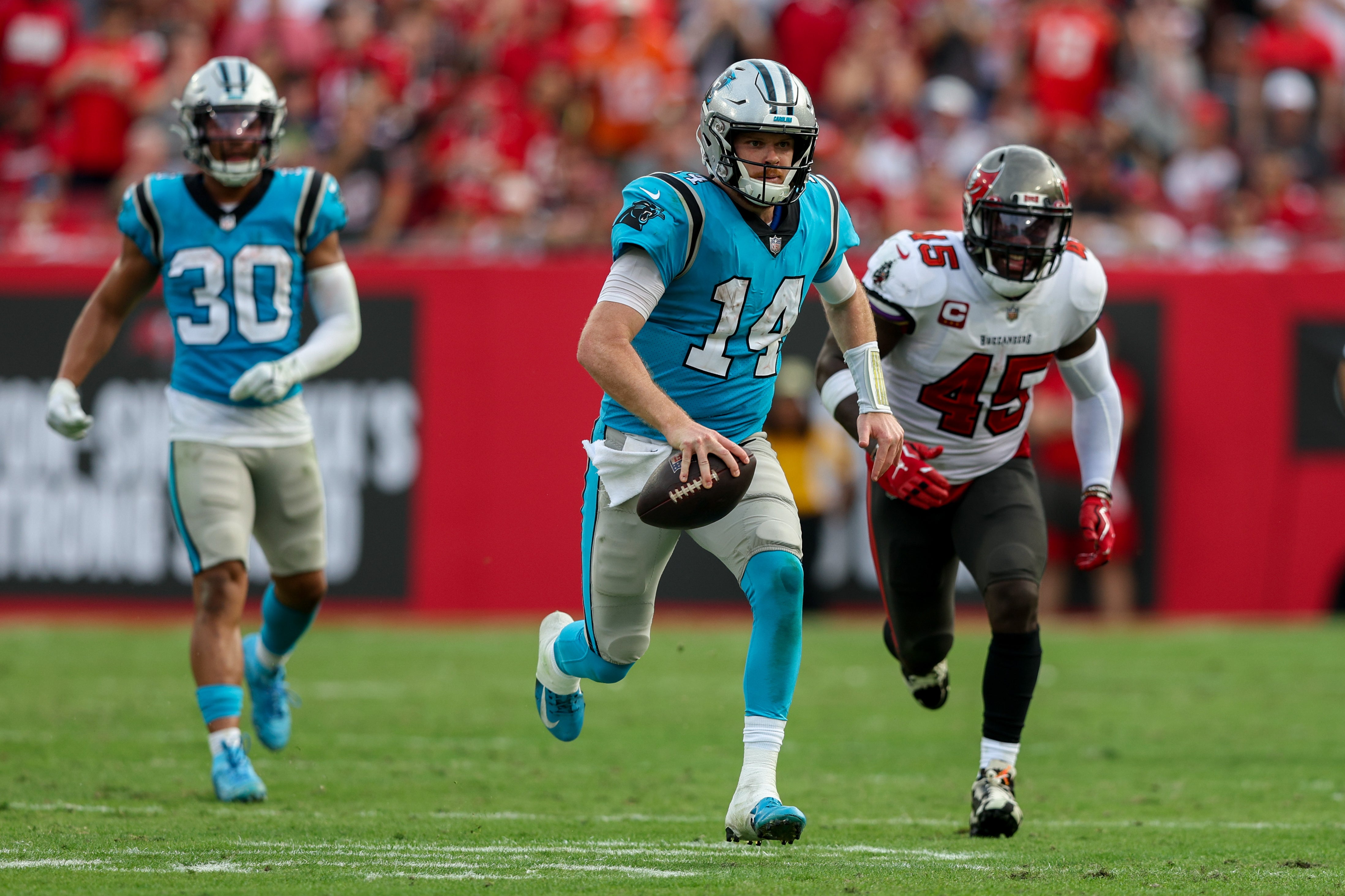 Carolina Panthers quarterback Sam Darnold (14) runs with the ball against the Tampa Bay Buccaneers in the fourth quarter at Raymond James Stadium.