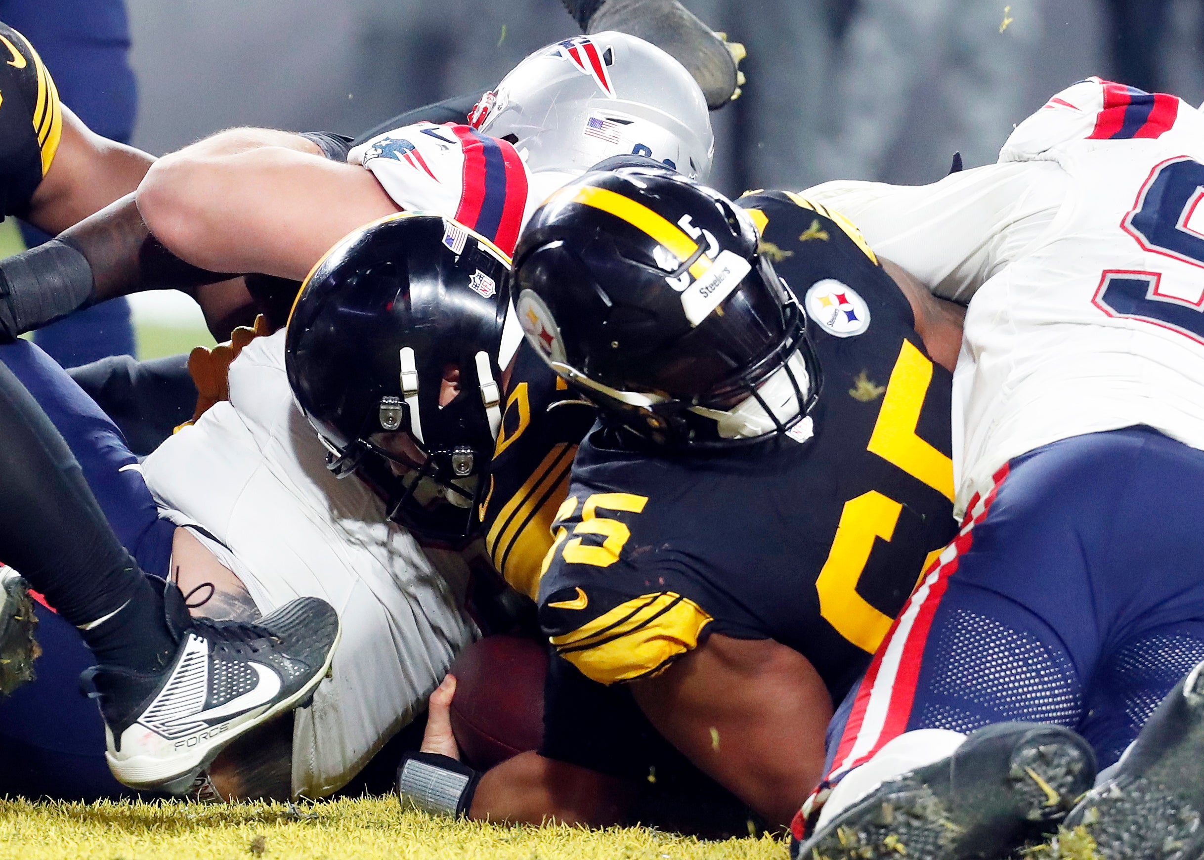 Dec 7, 2023; Pittsburgh, Pennsylvania, USA; Pittsburgh Steelers quarterback Mitch Trubisky (10) crosses the goal line behind offensive tackle Dan Moore Jr. (65) to score a touchdown against the New England Patriots during the fourth quarter at Acrisure Stadium. New England won 21-18. Mandatory Credit: Charles LeClaire-USA TODAY Sports