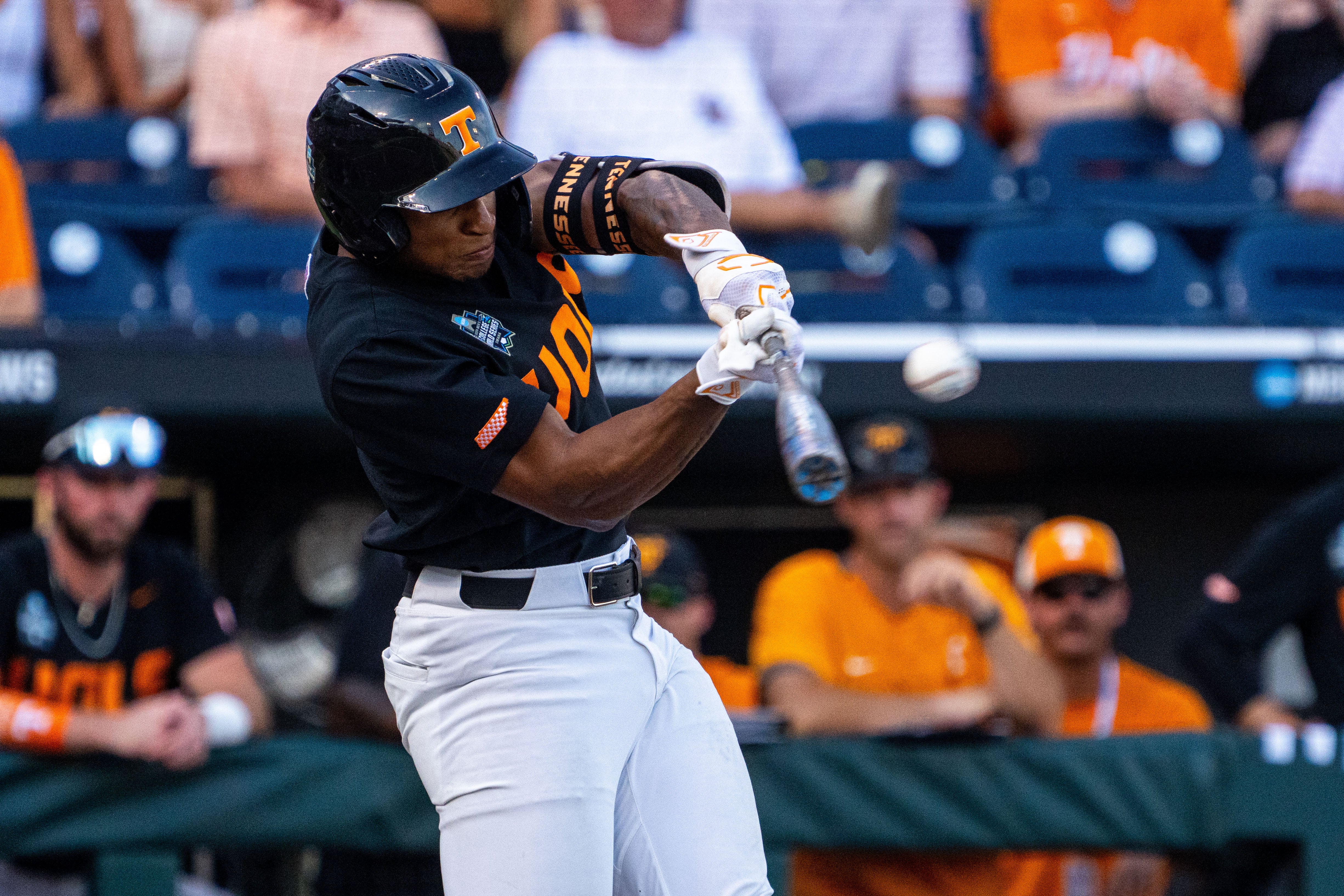 Jun 24, 2024; Omaha, NE, USA; Tennessee Volunteers second baseman Christian Moore (1) hits a home run against the Texas A&M Aggies during the first inning at Charles Schwab Field Omaha.