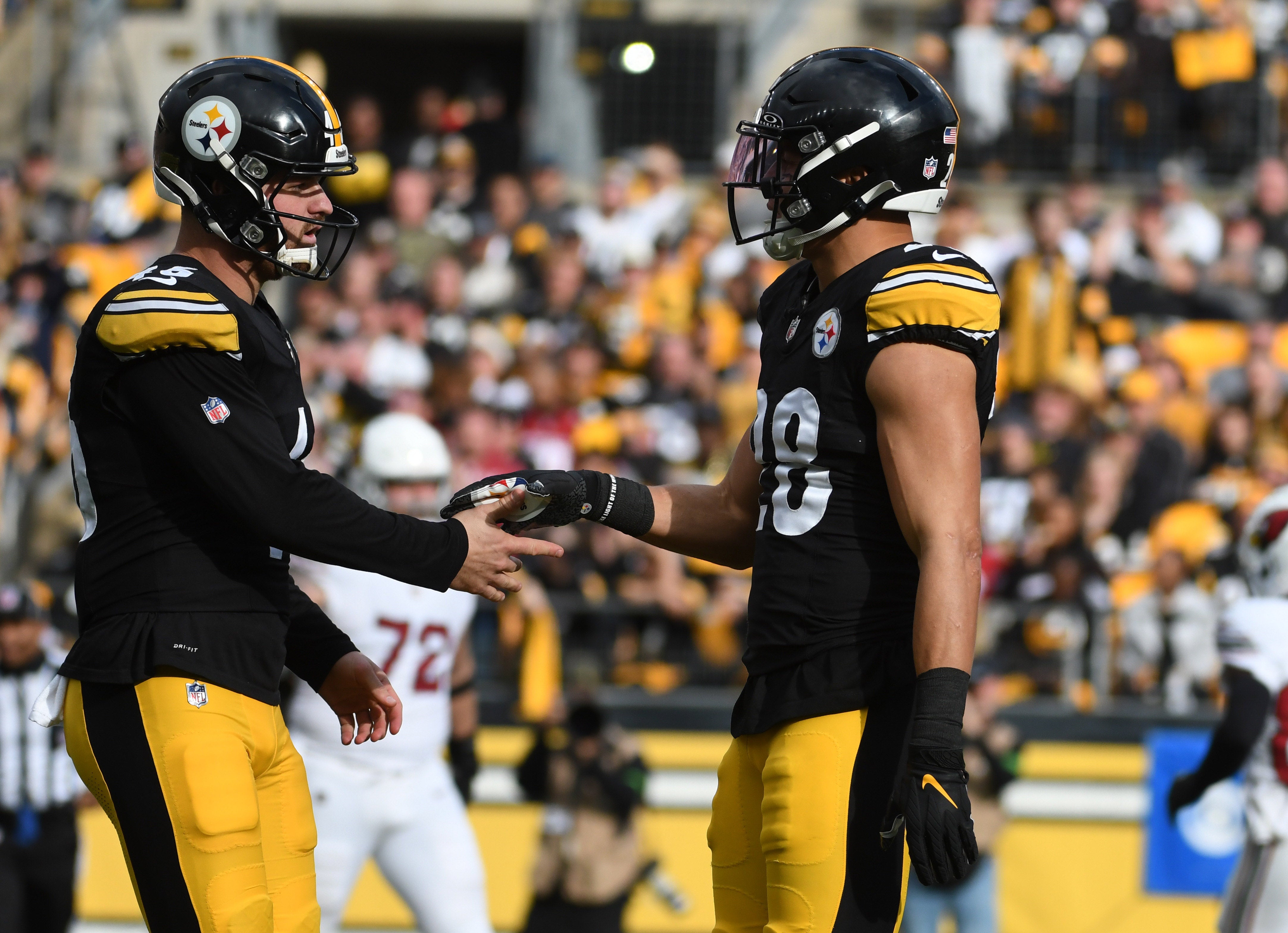 Dec 3, 2023; Pittsburgh, Pennsylvania, USA; Pittsburgh Steelers player Christian Kuntz (46) talks with special teams player Miles Killibrew (28) after getting flagged for for fair catch interference against the Arizona Cardinals at Acrisure Stadium. Mandatory Credit: Philip G. Pavely-USA TODAY Sports