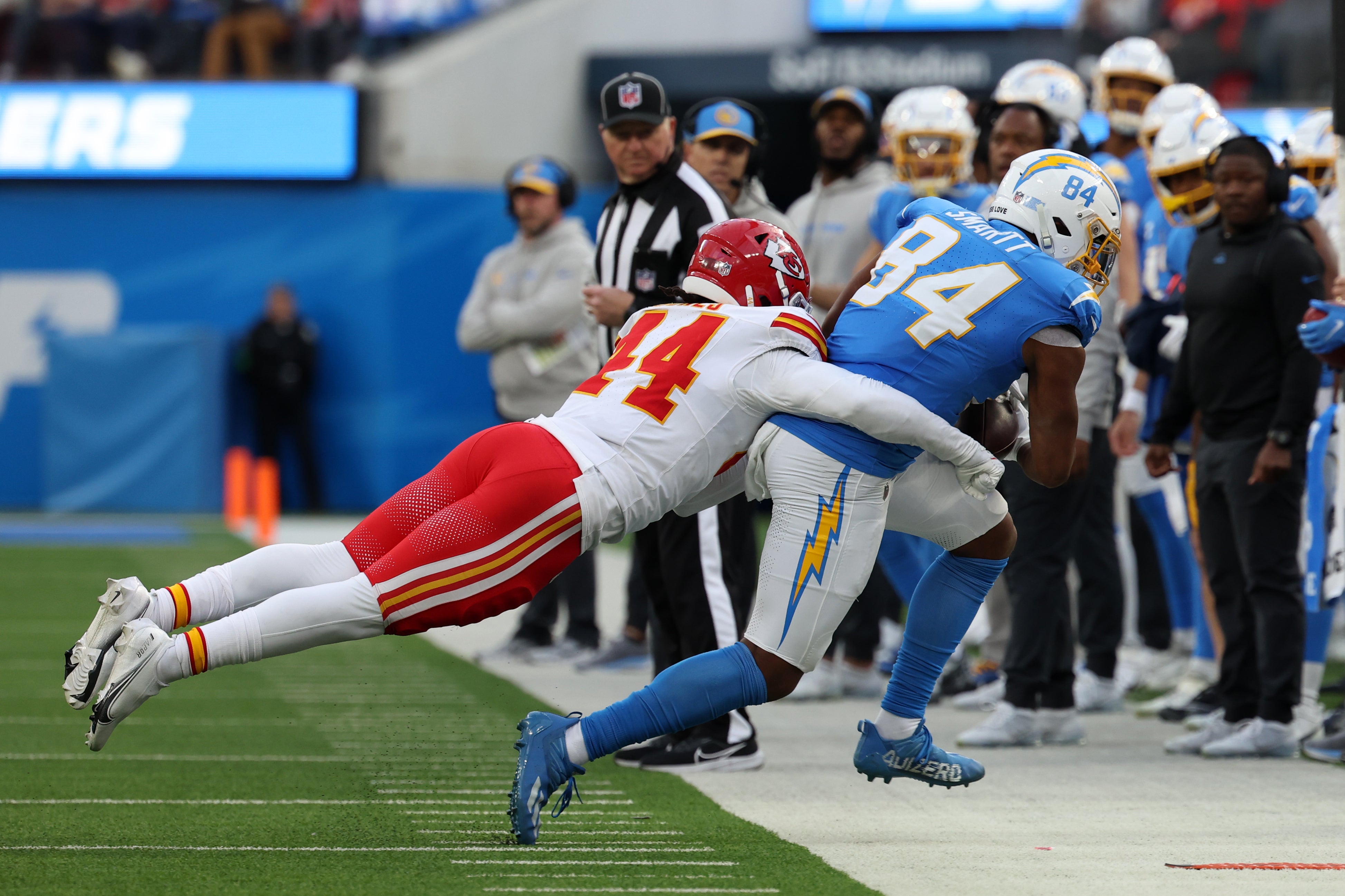 Jan 7, 2024; Inglewood, California, USA; Los Angeles Chargers tight end Stone Smartt (84) is tackled by Kansas City Chiefs linebacker Cam Jones (44) during the second quarter at SoFi Stadium.