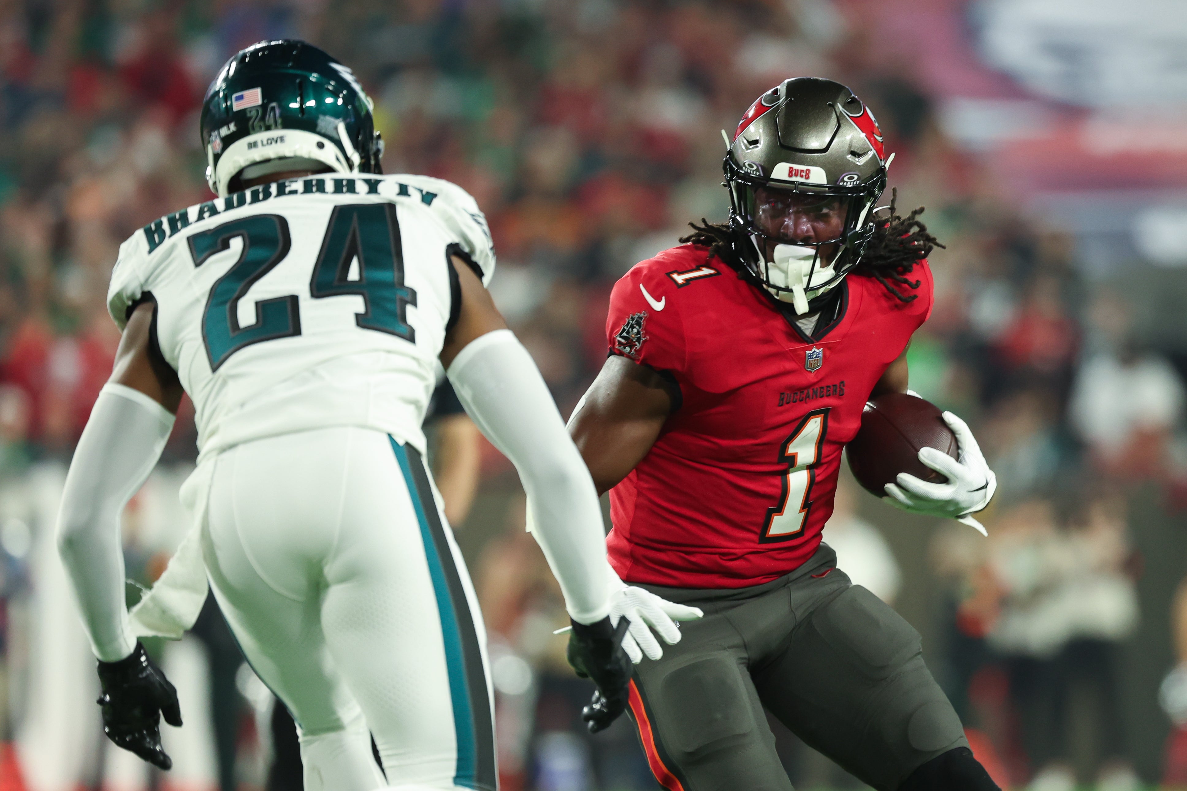 Tampa Bay Buccaneers running back Rachaad White (1) runs the ball as Philadelphia Eagles cornerback James Bradberry (24) defends during the first half of a 2024 NFC wild card game at Raymond James Stadium.