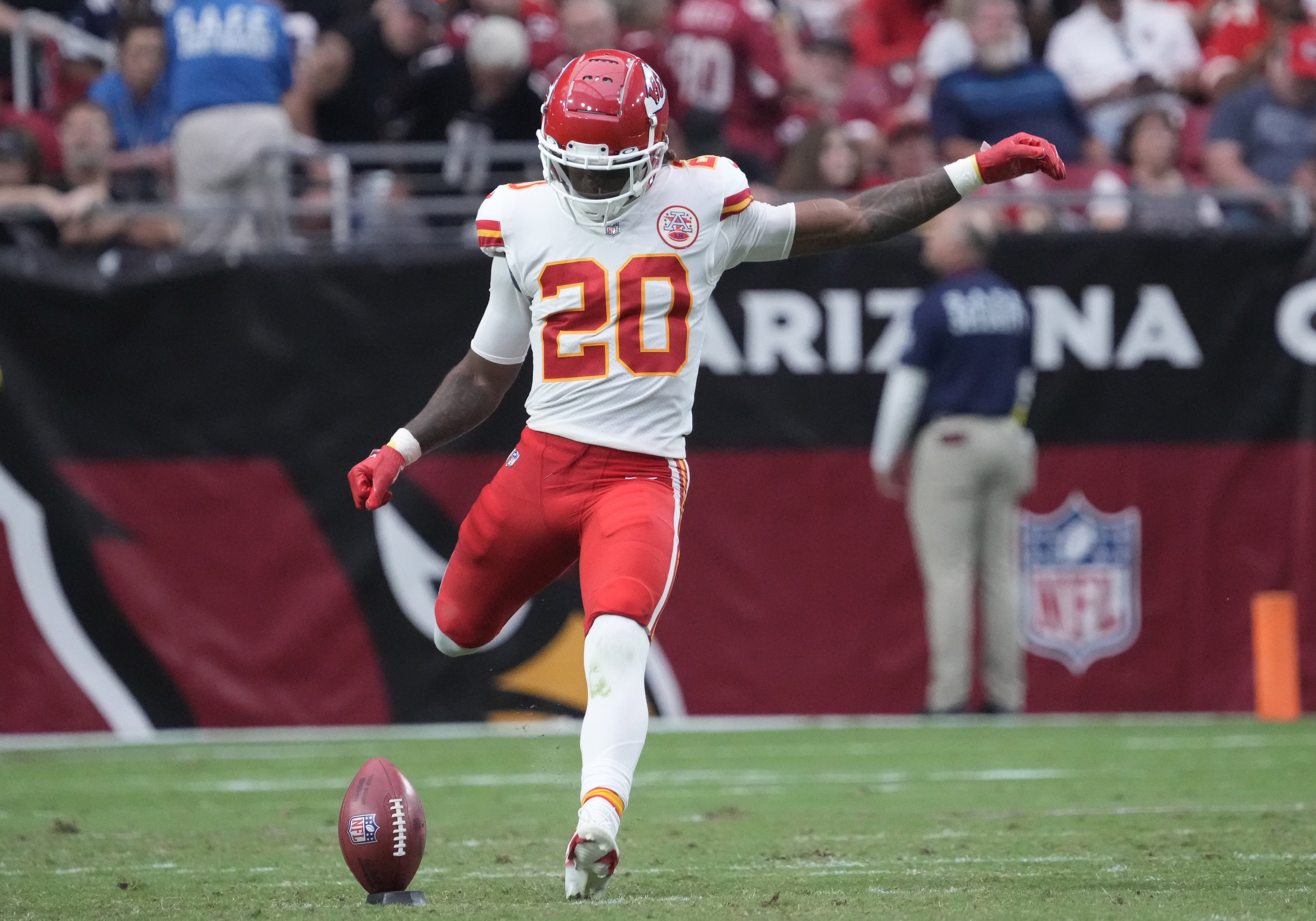 Sep 11, 2022; Glendale, Arizona, United States; Kansas City Chiefs safety Justin Reid (20) kicks off against the Arizona Cardinals during the third quarter at State Farm Stadium.