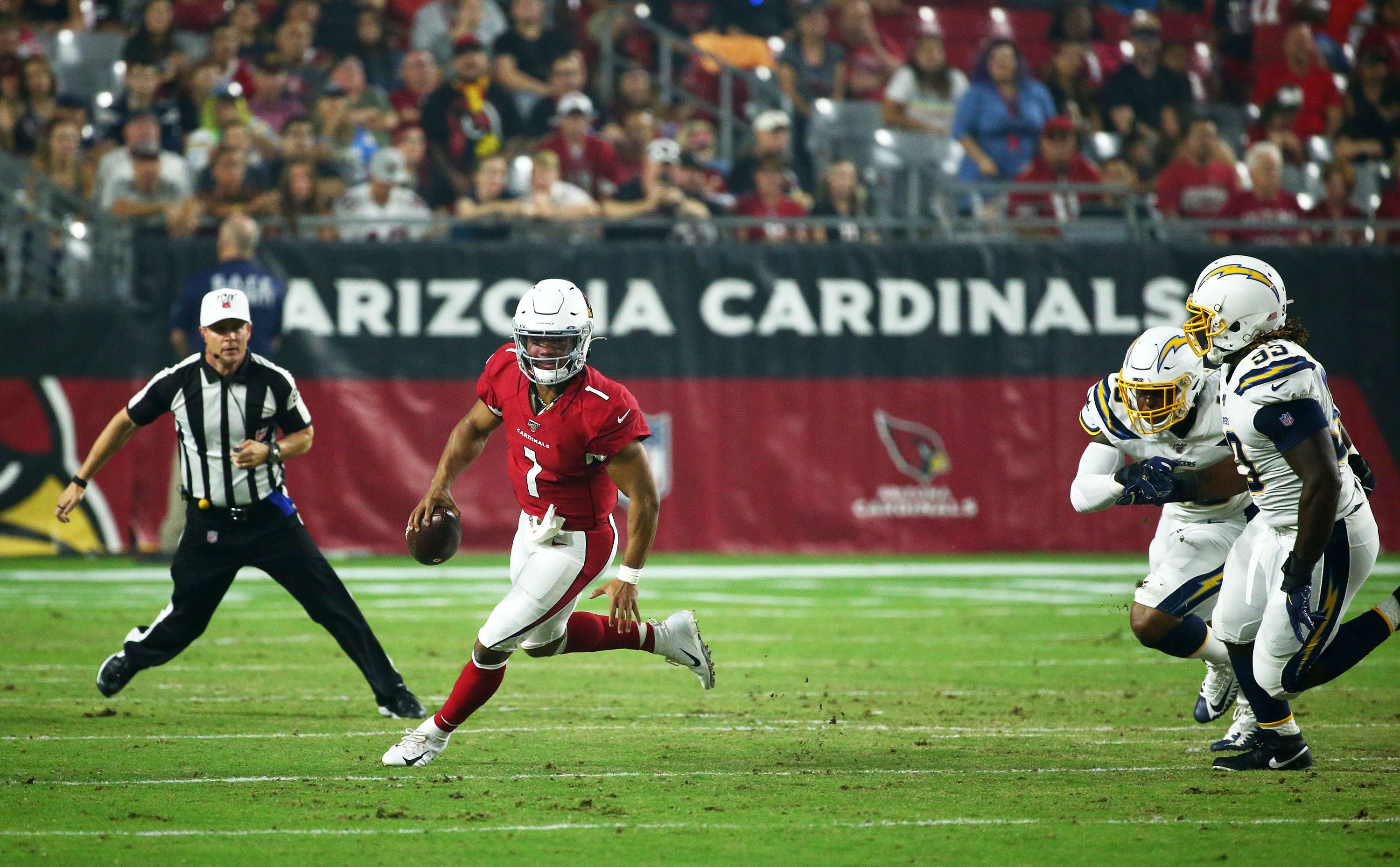 Arizona Cardinals quarterback Kyler Murray (1) eludes Los Angeles Chargers linebacker Chris Peace (40) and defensive tackle Justin Jones (93) in the first half during a preseason game on Aug. 8, 2019 in Glendale, Ariz.