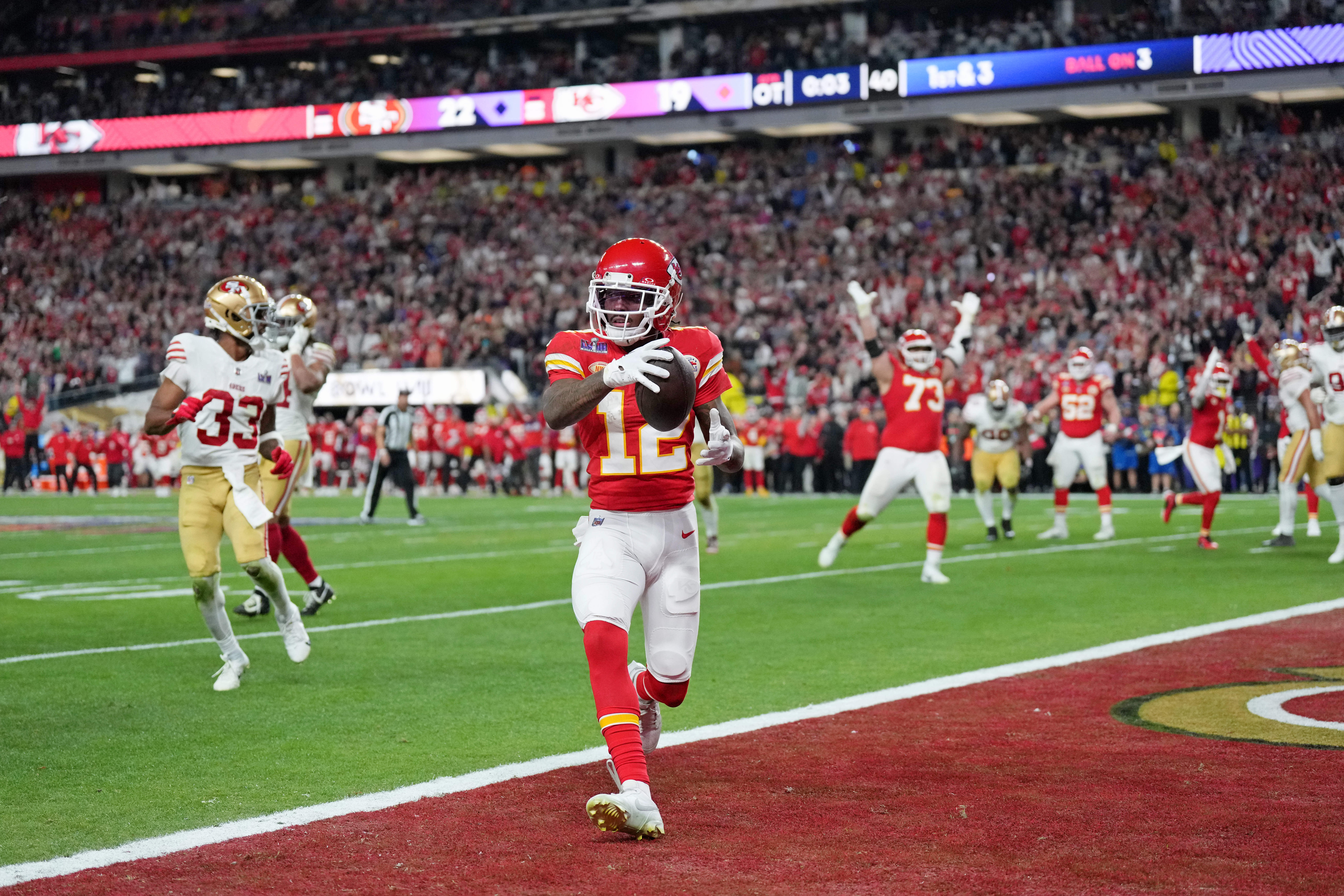 Feb 11, 2024; Paradise, Nevada, USA; Kansas City Chiefs wide receiver Mecole Hardman Jr. (12) scores a touchdown against the San Francisco 49ers in overtime during Super Bowl LVIII at Allegiant Stadium.