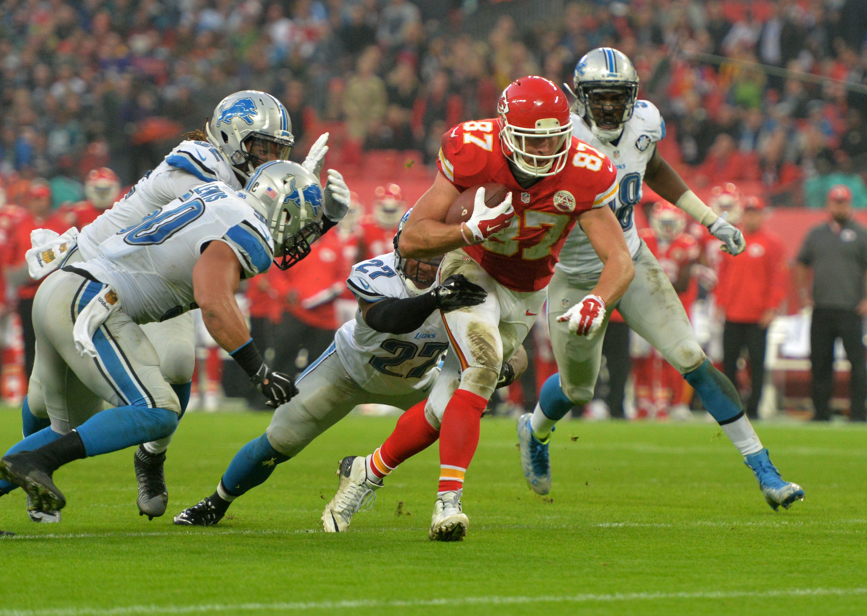 Nov 1, 2015; London, United Kingdom; Kansas City Chiefs tight end Travis Kelce (87) is defended by Detroit Lions safety Glover Quin (57) and linebacker Travis Lewis (50) on a 2-yard touchdown reception during game 14 of the NFL International Series at Wembley Stadum. The Chiefs defeated the Lions 45-10.