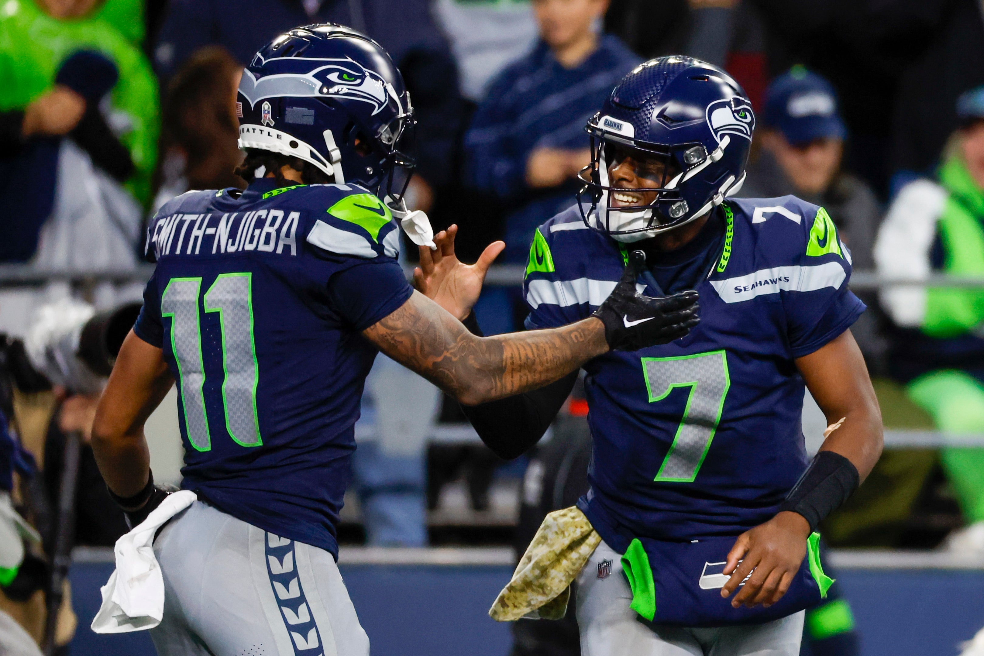 Nov 12, 2023; Seattle, Washington, USA; Seattle Seahawks quarterback Geno Smith (7) celebrates with wide receiver Jaxon Smith-Njigba (11) after throwing a touchdown pass against the Washington Commanders during the fourth quarter at Lumen Field.