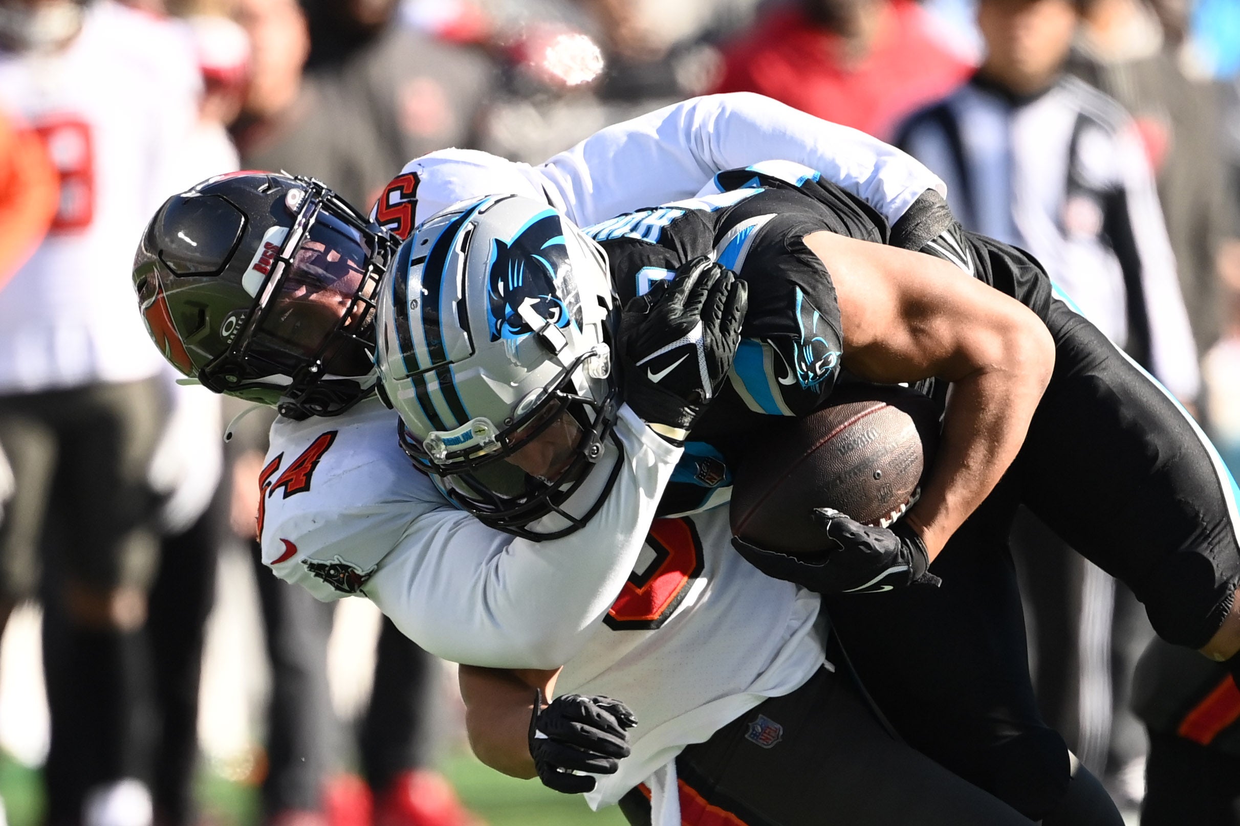 Jan 7, 2024; Charlotte, North Carolina, USA; Carolina Panthers running back Chuba Hubbard (30) is tackled by Tampa Bay Buccaneers linebacker Lavonte David (54) in the second quarter at Bank of America Stadium. Mandatory Credit: Bob Donnan-USA TODAY Sports