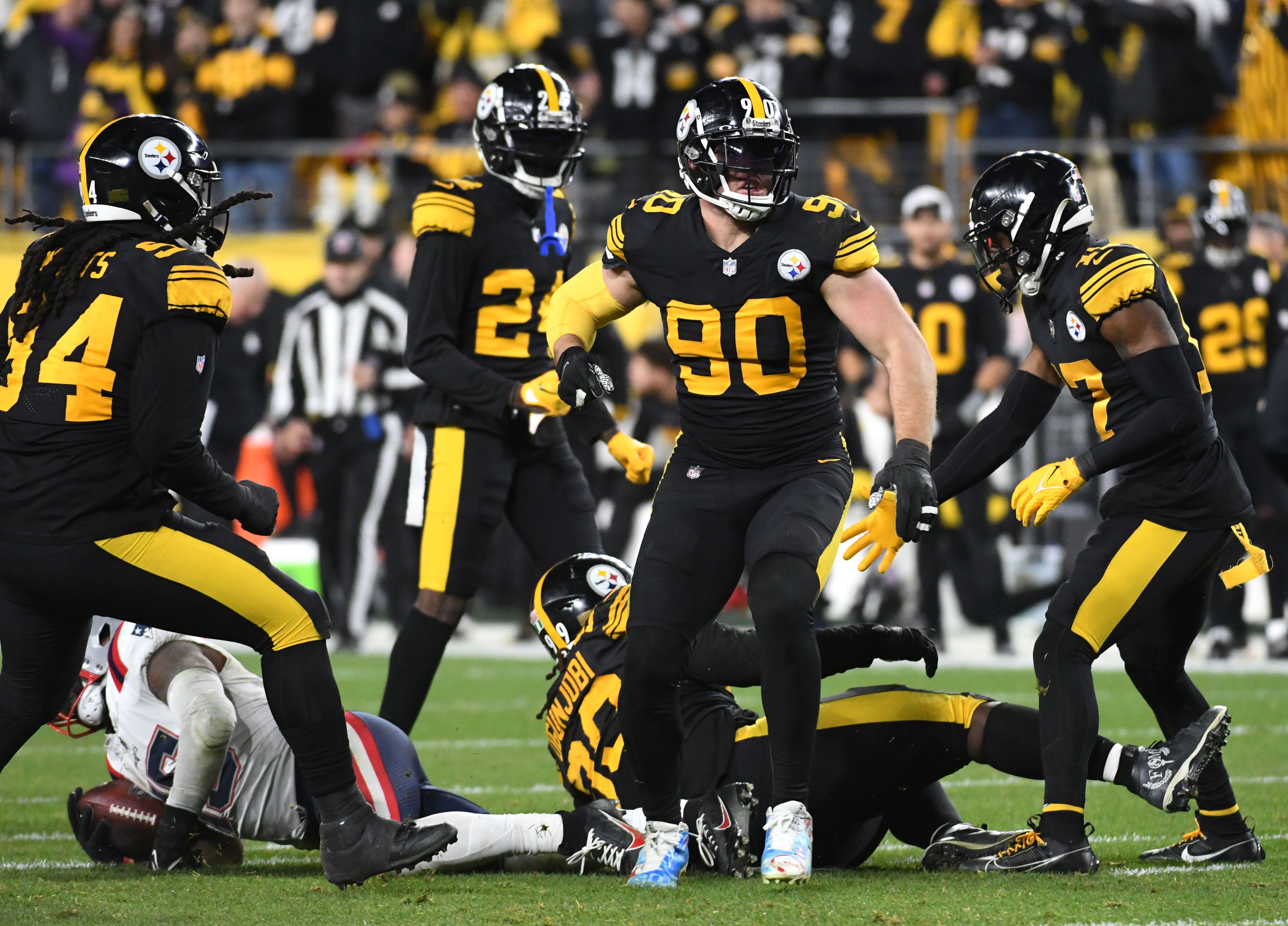 Dec 7, 2023; Pittsburgh, Pennsylvania, USA; Pittsburgh Steelers linebacker T.J. Watt (90) celebrates a tackle of New England Patriots running back Ezekiel Elliott (15) during the fourth quarter at Acrisure Stadium. The Patriots won 21-18. Mandatory Credit: Philip G. Pavely-USA TODAY Sports