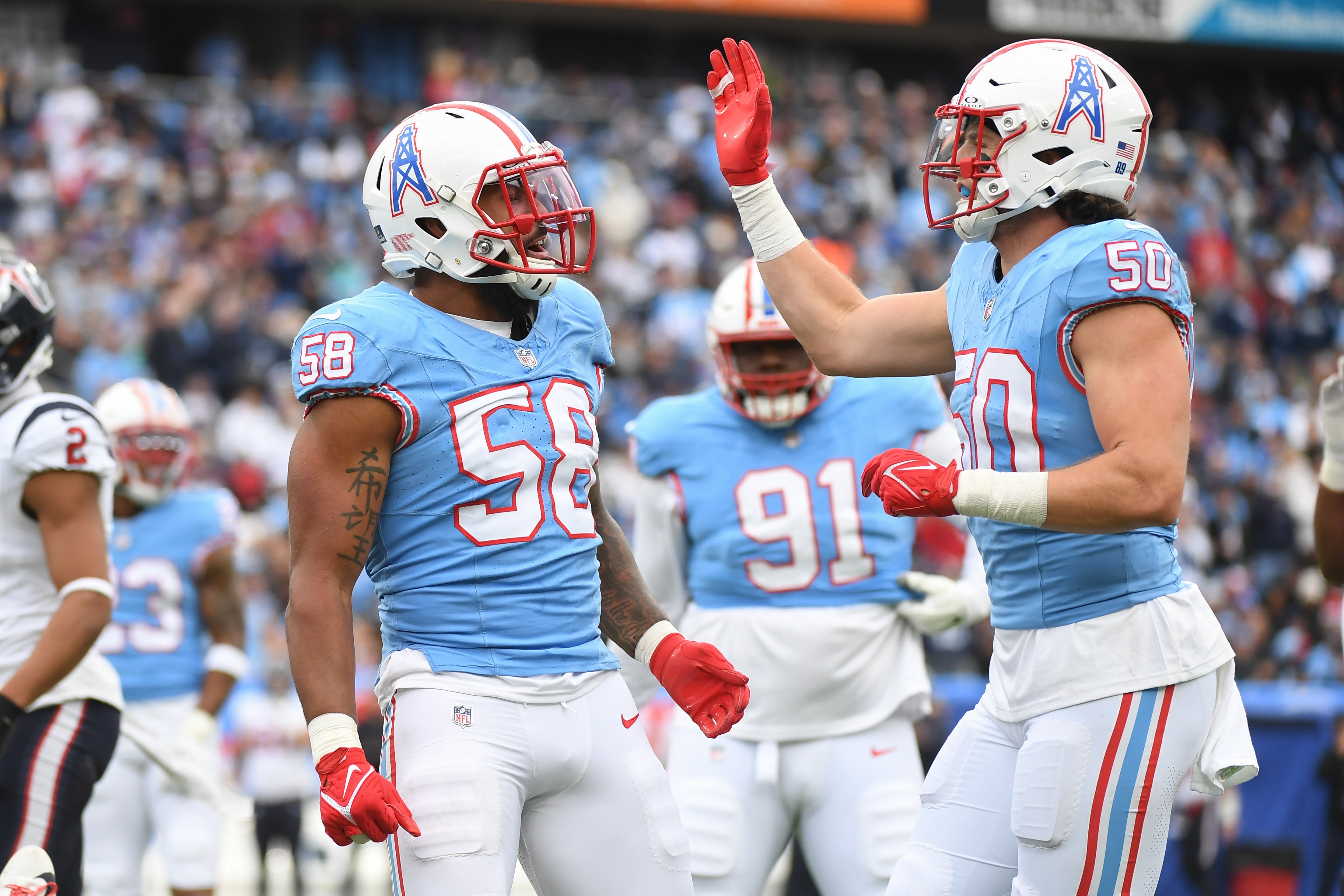 Tennessee Titans linebacker Harold Landry III (58) and linebacker Jack Gibbens (50) celebrate after a defensive stop during the first half against the Houston Texans at Nissan Stadium. Christopher Hanewinckel-USA TODAY Sports