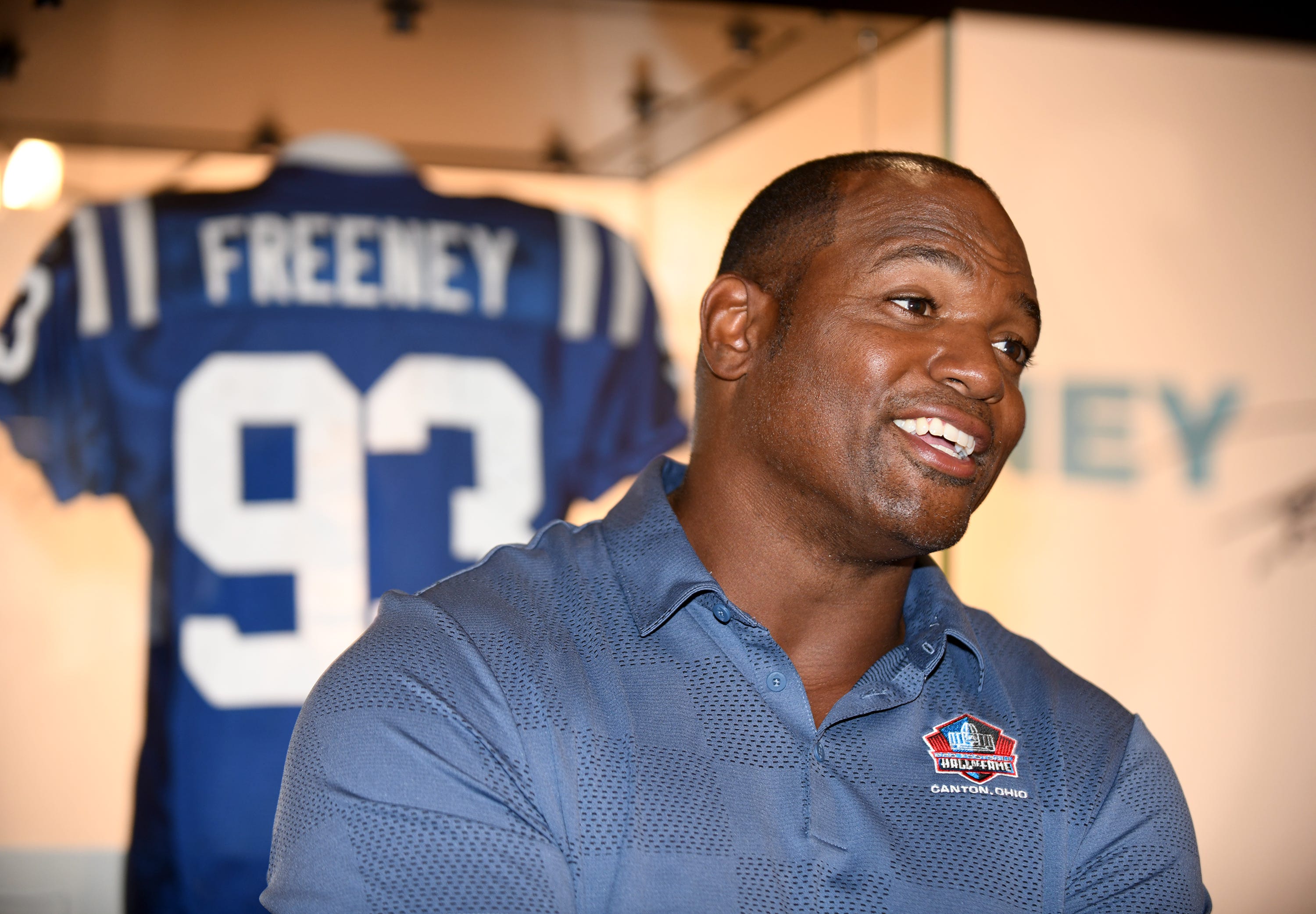 Dwight Freeney, a member of the Pro Football Hall of Fame's Class of 2024, talks with visitors during a visit to the Hall, Friday, May 24, 2024.