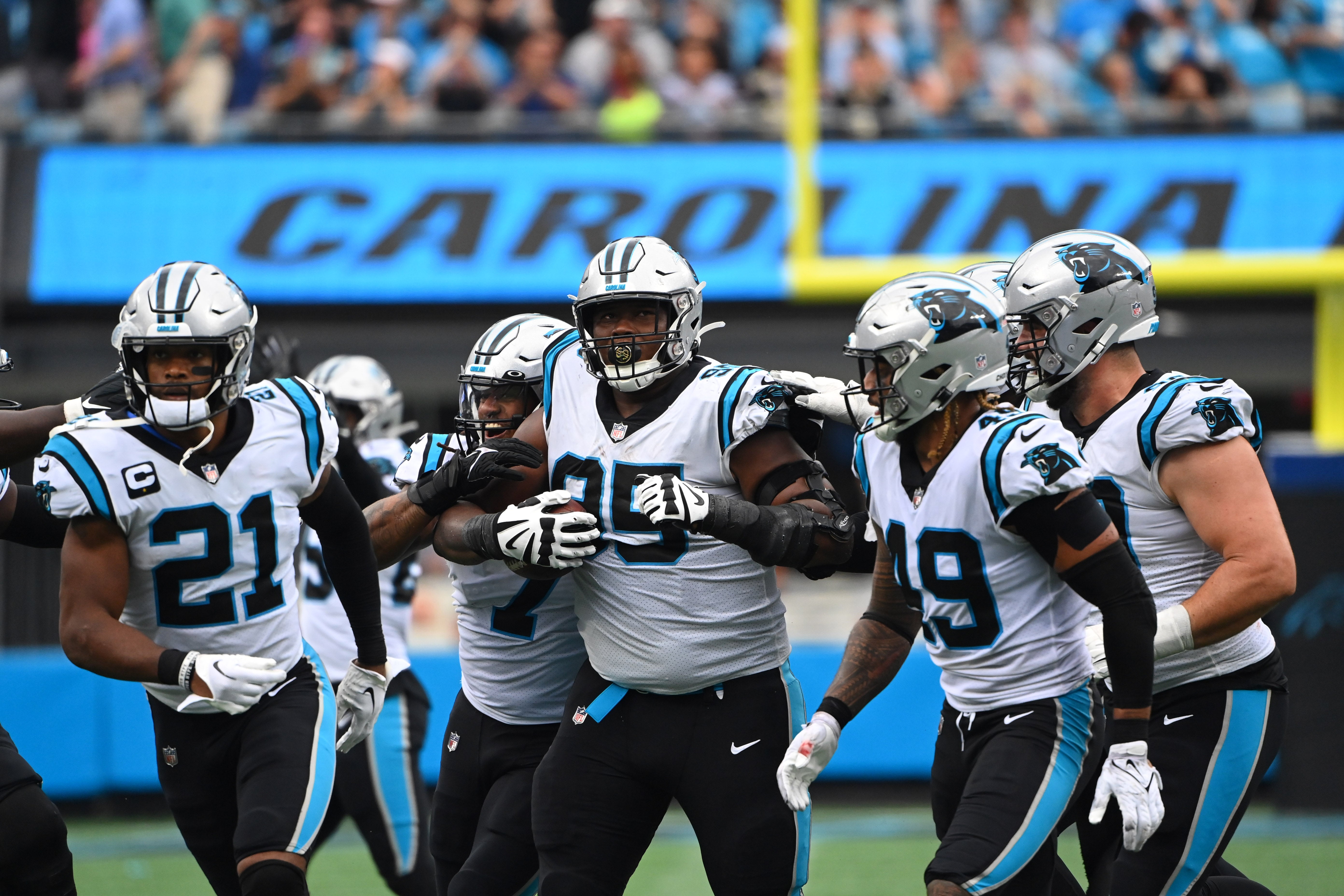Sep 25, 2022; Charlotte, North Carolina, USA; Carolina Panthers defensive tackle Derrick Brown (95) celebrates with safety Jeremy Chinn (21) and linebacker Shaq Thompson (7) and linebacker Frankie Luvu (49) and defensive tackle Matt Ioannidis (99) after intercepting a pass in the fourth quarter at Bank of America Stadium. Mandatory Credit: Bob Donnan-USA TODAY Sports