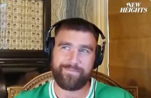 Travis Kelce appears distracted during the latest episode of the New Heights podcast.