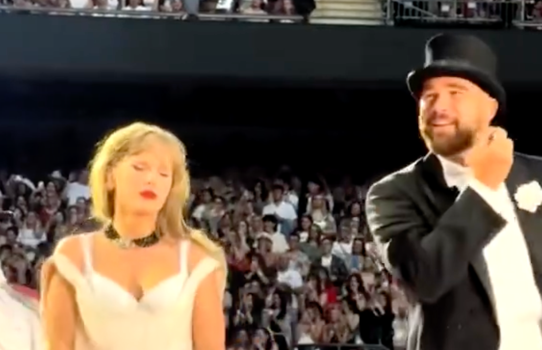 Travis Kelce on stage with Taylor Swift during Night 3 Eras Tour performance at Wembley Stadium.