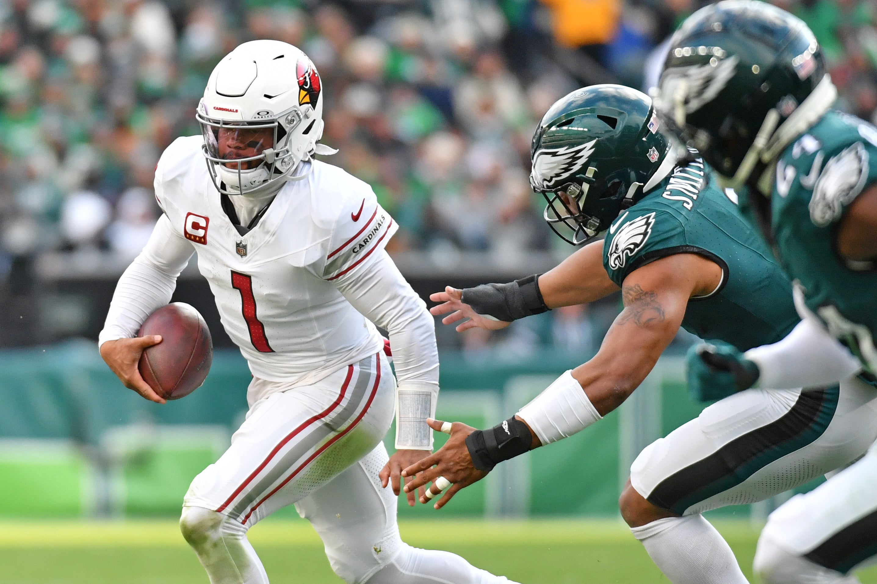 Arizona Cardinals quarterback Kyler Murray (1) runs past Philadelphia Eagles linebacker Nolan Smith (3) during the second quarter at Lincoln Financial Field.