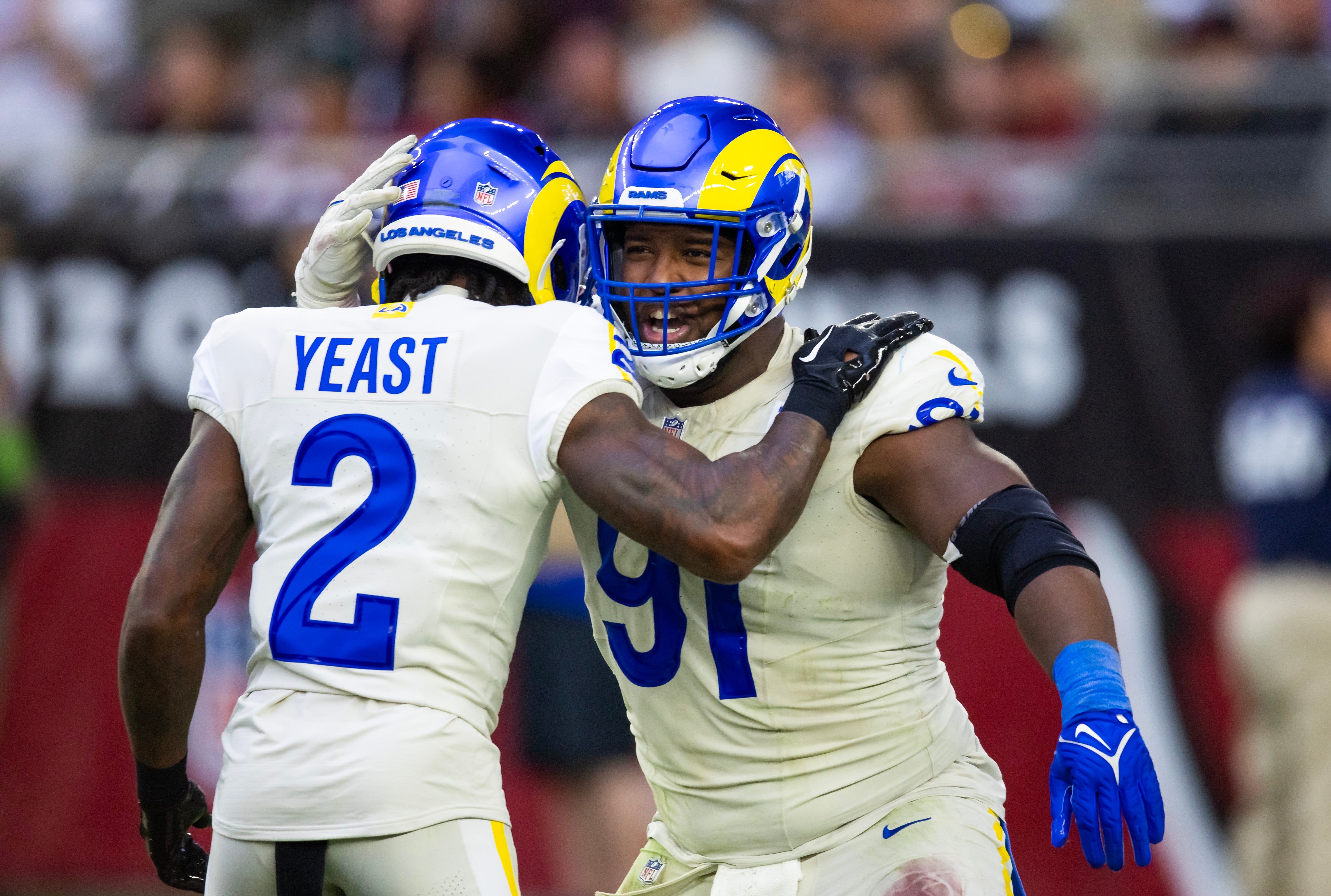 Nov 26, 2023; Glendale, Arizona, USA; Los Angeles Rams defensive tackle Kobie Turner (91) celebrates a play with safety Russ Yeast (2) against the Arizona Cardinals at State Farm Stadium. Mandatory Credit: Mark J. Rebilas-USA TODAY Sports