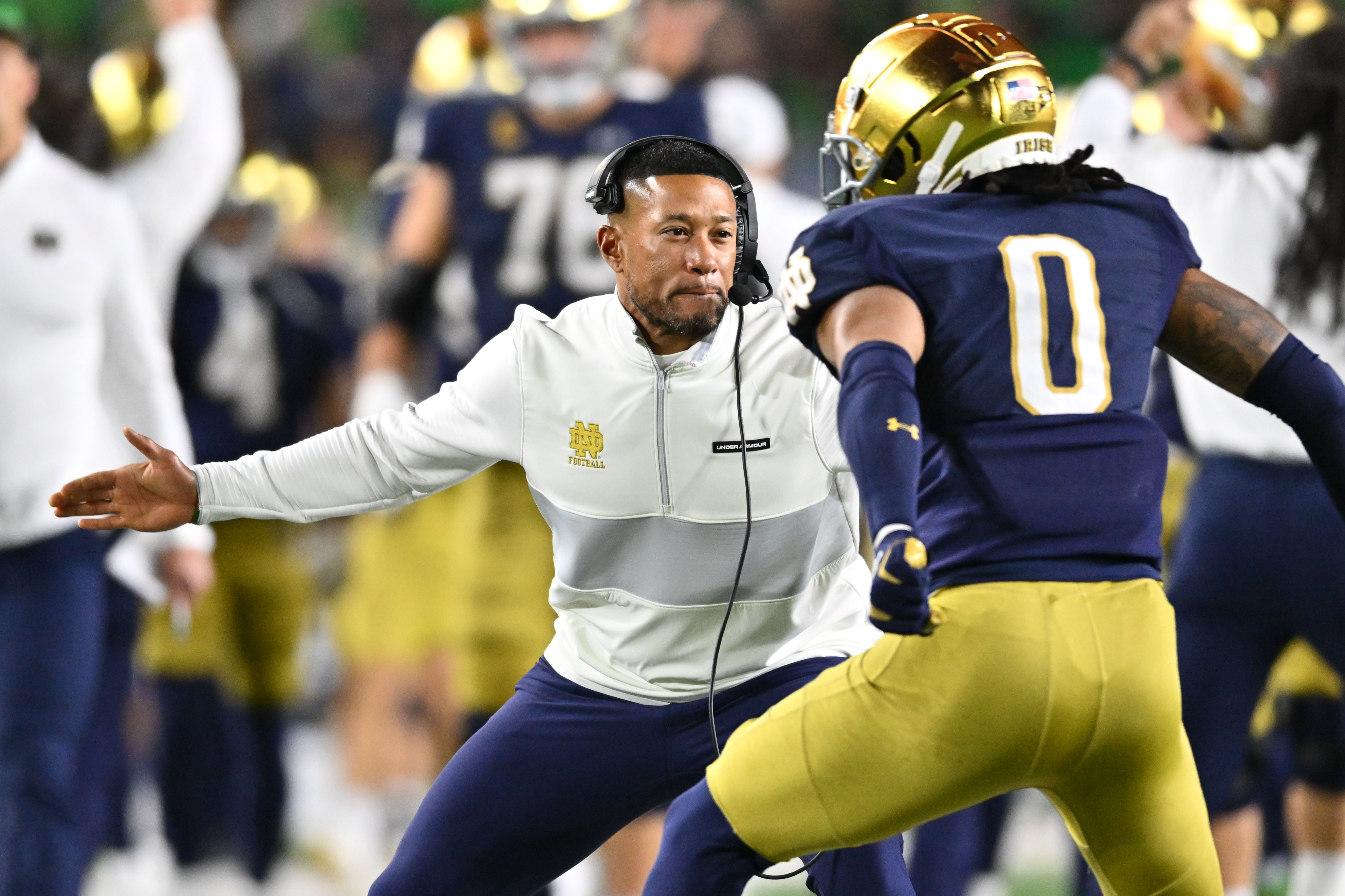 Oct 14, 2023; South Bend, Indiana, USA; Notre Dame Fighting Irish head coach Marcus Freeman celebrates with safety Xavier Watts (0) after Watts intercepted a pass in the first quarter against the USC Trojans at Notre Dame Stadium. Notre Dame won 48-20.
