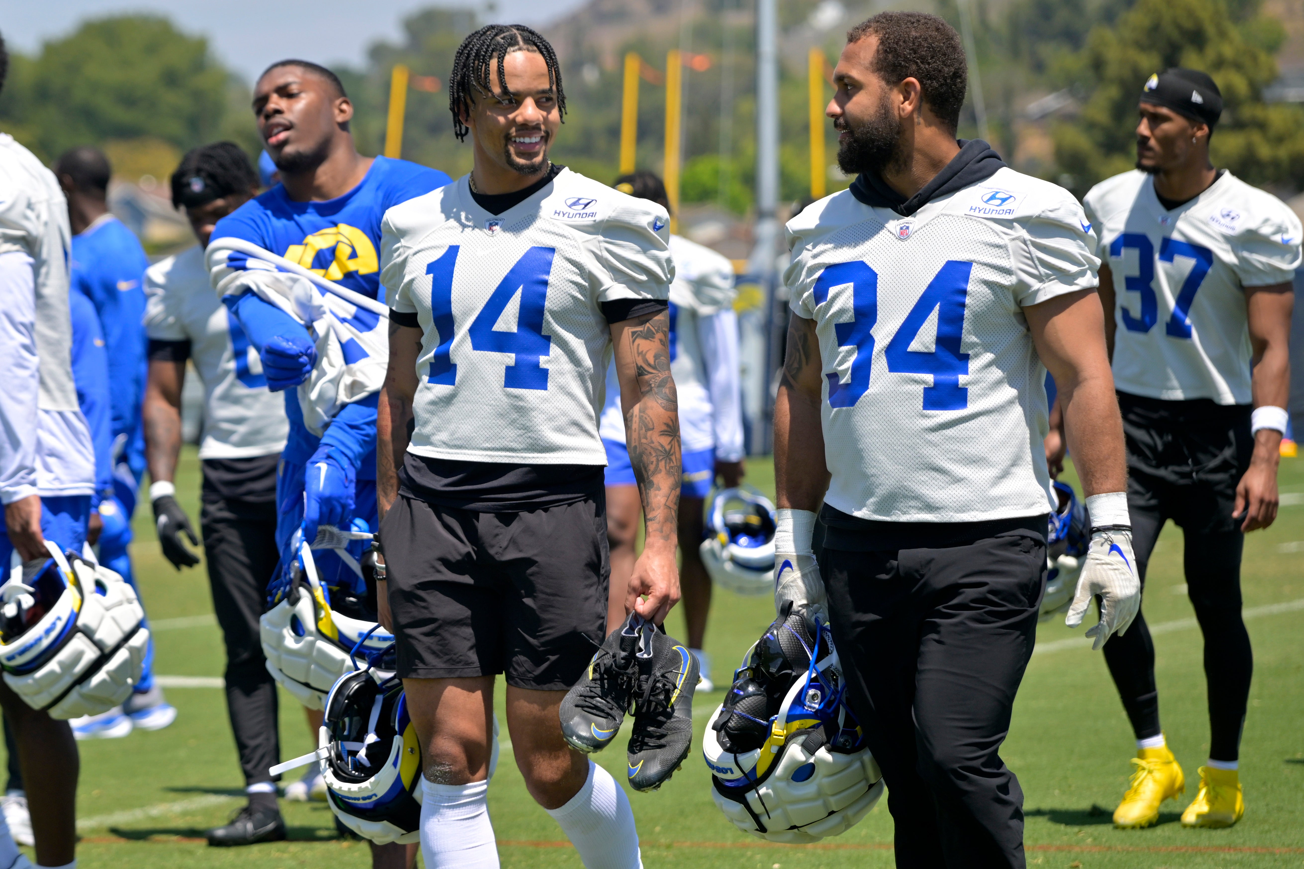 May 28, 2024; Thousand Oaks, CA, USA; Los Angeles Rams cornerback Cobie Durant (14) and safety Tanner Ingle (34) leave the field following OTAs at the team training facility at California Lutheran University. Mandatory Credit: Jayne Kamin-Oncea-USA TODAY Sports