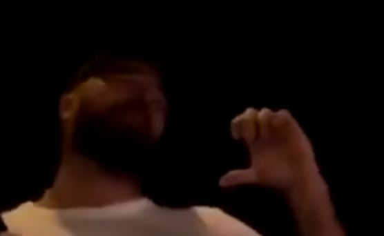 Travis Kelce makes a heart hand during Taylor Swift's N3 Eras Tour show in Amsterdam.