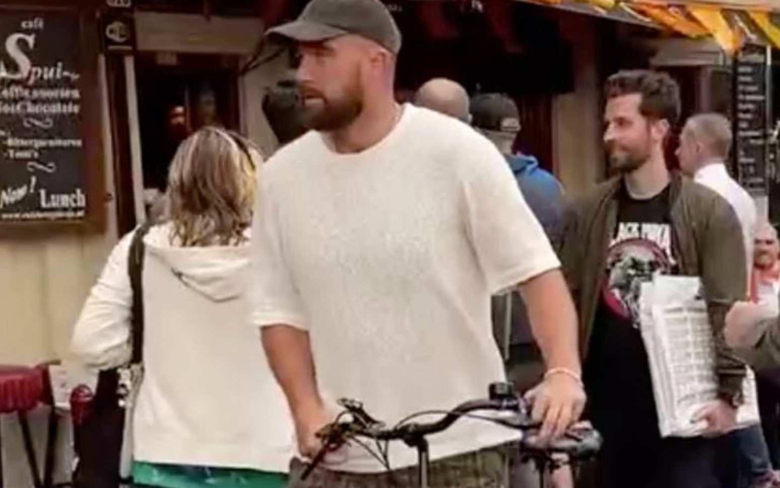 Travis Kelce is seen riding a bike around Amsterdam ahead of Taylor Swift's Eras Tour show.