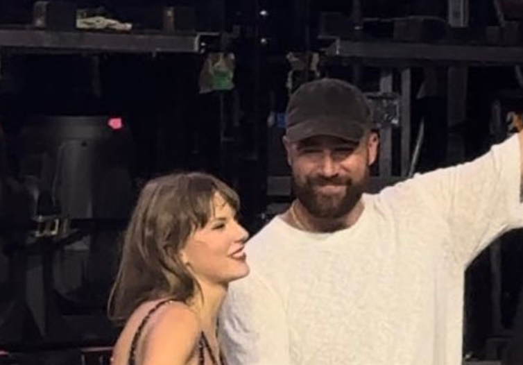 Travis Kelce leaves the stage with Taylor Swift after her third and final show in Amsterdam on Saturday night.