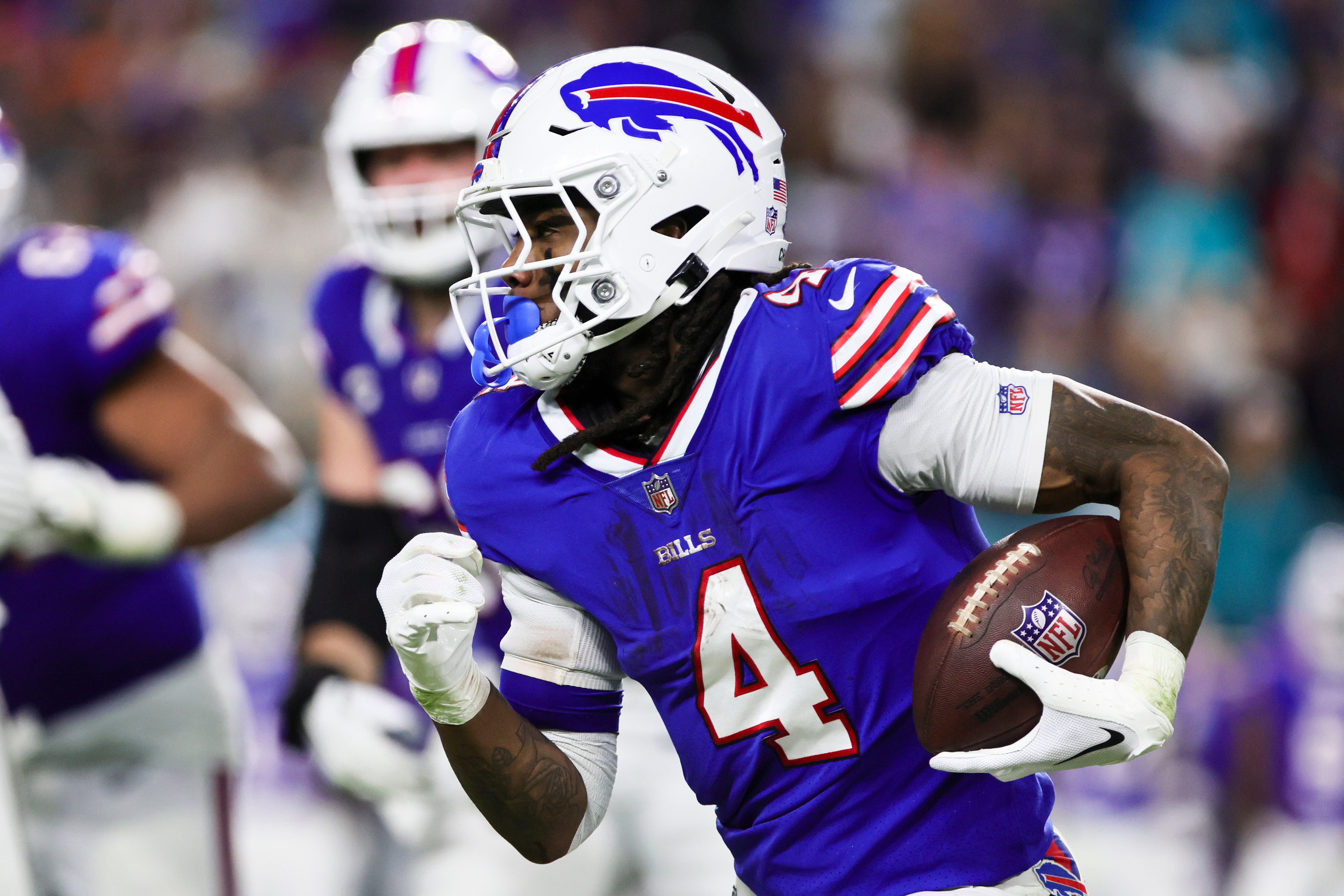 Jan 7, 2024; Miami Gardens, Florida, USA; Buffalo Bills running back James Cook (4) runs with the football against the Miami Dolphins during the fourth quarter at Hard Rock Stadium.