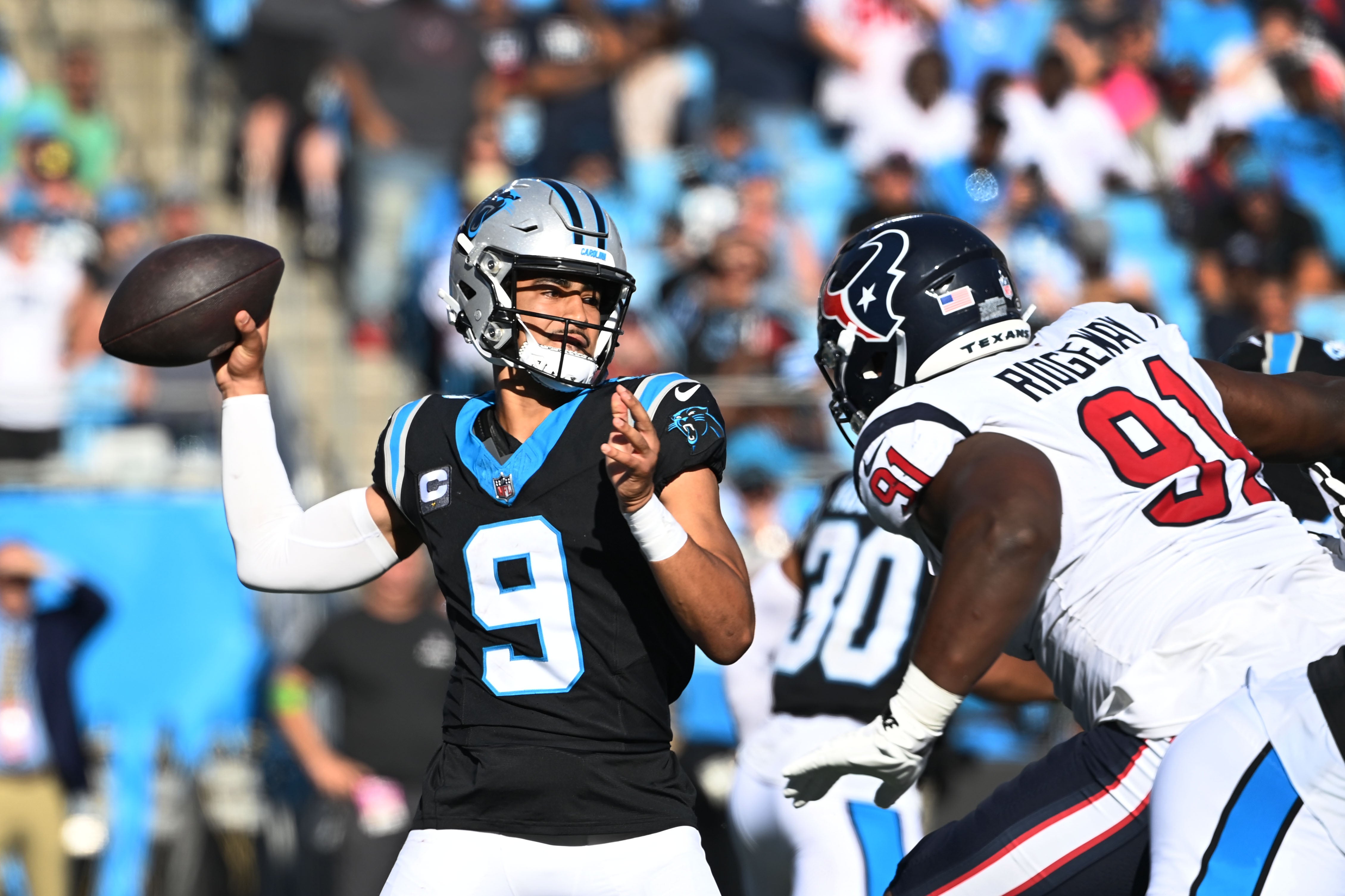 Oct 29, 2023; Charlotte, North Carolina, USA; Carolina Panthers quarterback Bryce Young (9) passes the ball as Houston Texans defensive tackle Hassan Ridgeway (91) pressures in the fourth quarter at Bank of America Stadium. Mandatory Credit: Bob Donnan-USA TODAY Sports