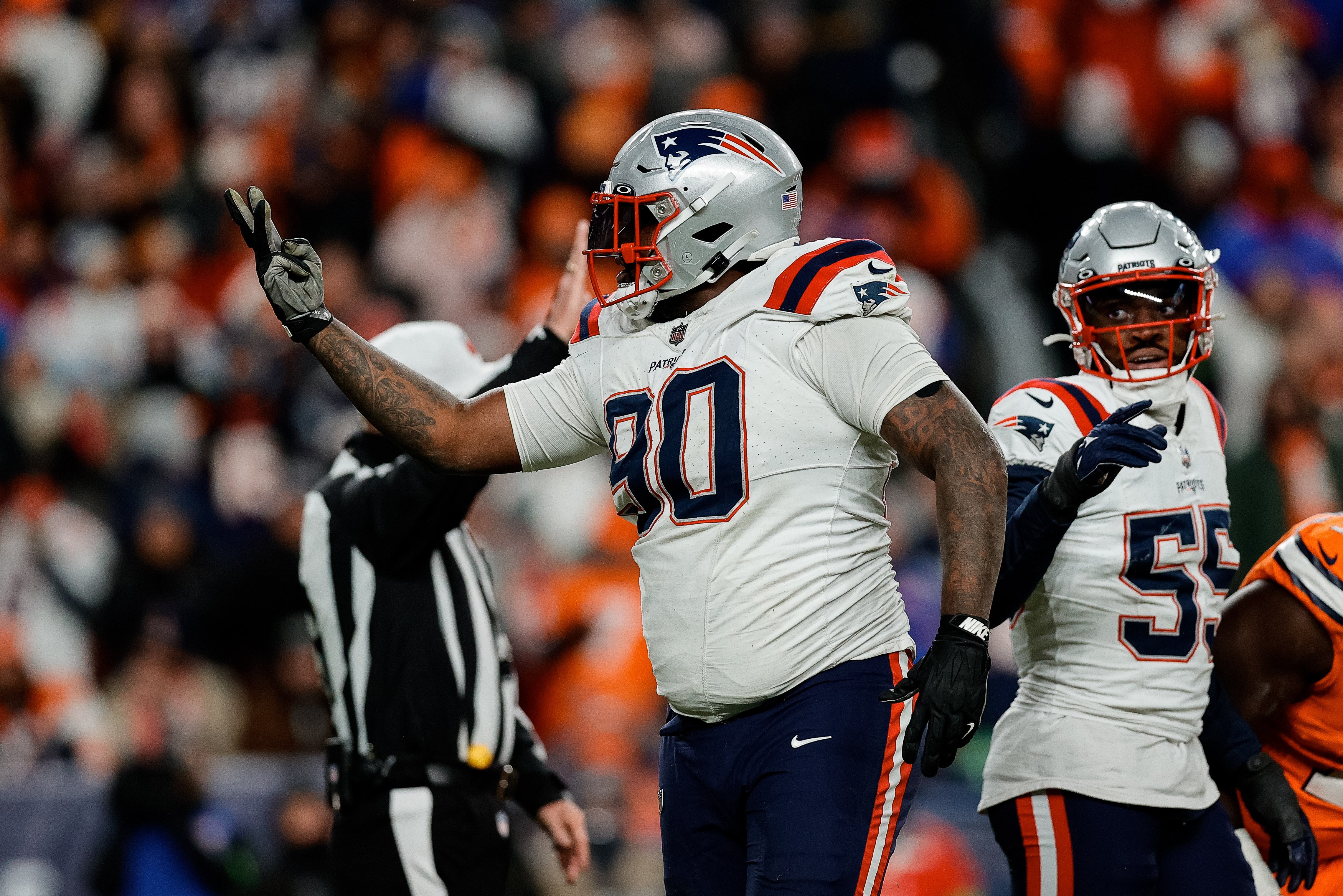 Dec 24, 2023; Denver, Colorado, USA; New England Patriots defensive tackle Christian Barmore (90) reacts after a play ]in the third quarter against the Denver Broncos at Empower Field at Mile High.