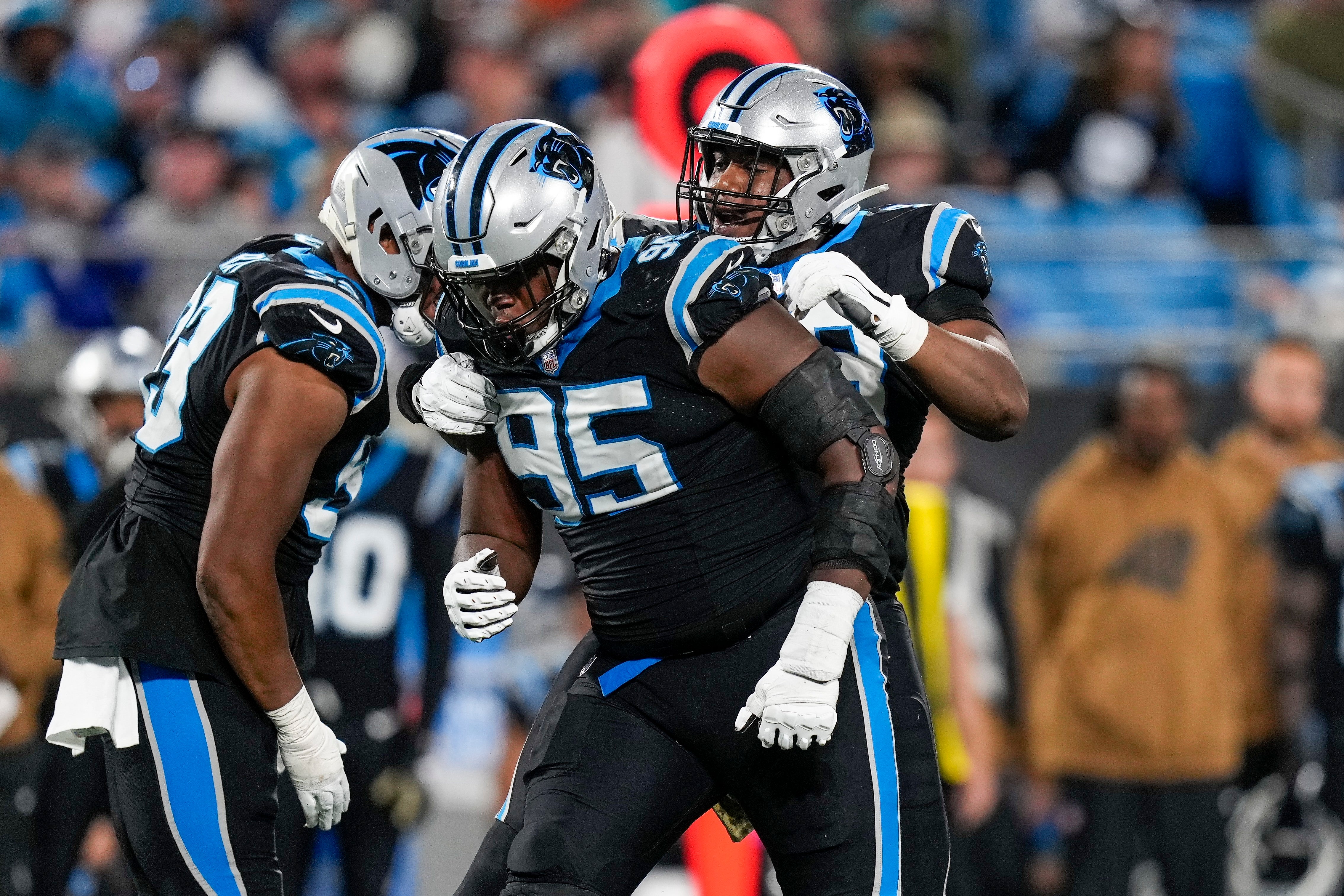 Nov 5, 2023; Charlotte, North Carolina, USA; Carolina Panthers defensive tackle Derrick Brown (95) and linebacker Amare Barno (90) react to a sack by Brown against the Indianapolis Colts during the second half at Bank of America Stadium. Mandatory Credit: Jim Dedmon-USA TODAY Sports
