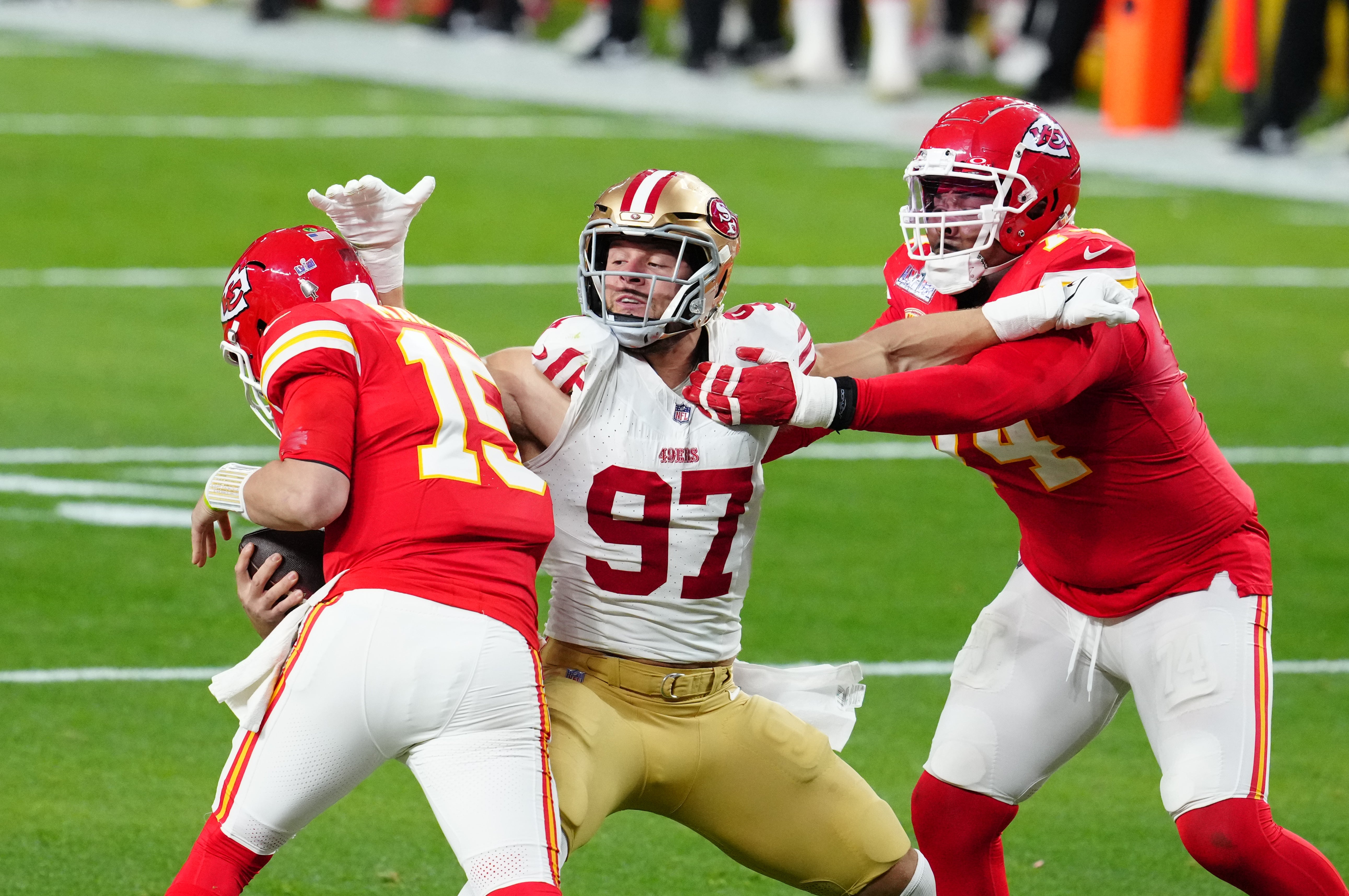 Feb 11, 2024; Paradise, Nevada, USA; Kansas City Chiefs quarterback Patrick Mahomes (15) is pressured by San Francisco 49ers defensive end Nick Bosa (97) in the first half in Super Bowl LVIII at Allegiant Stadium.