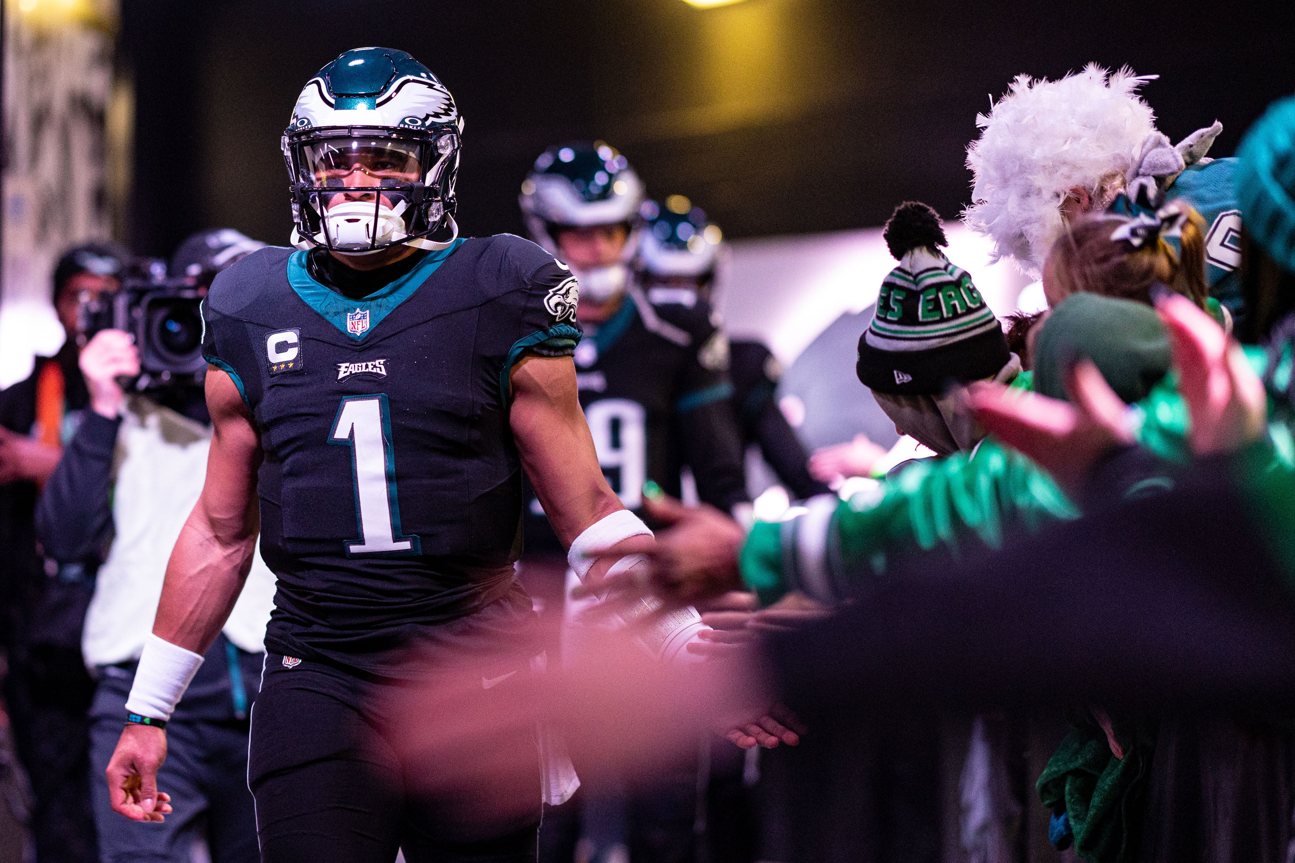 Philadelphia Eagles quarterback Jalen Hurts (1) high fives fans as he walks from the locker room for a game against the New York Giants at Lincoln Financial Field.