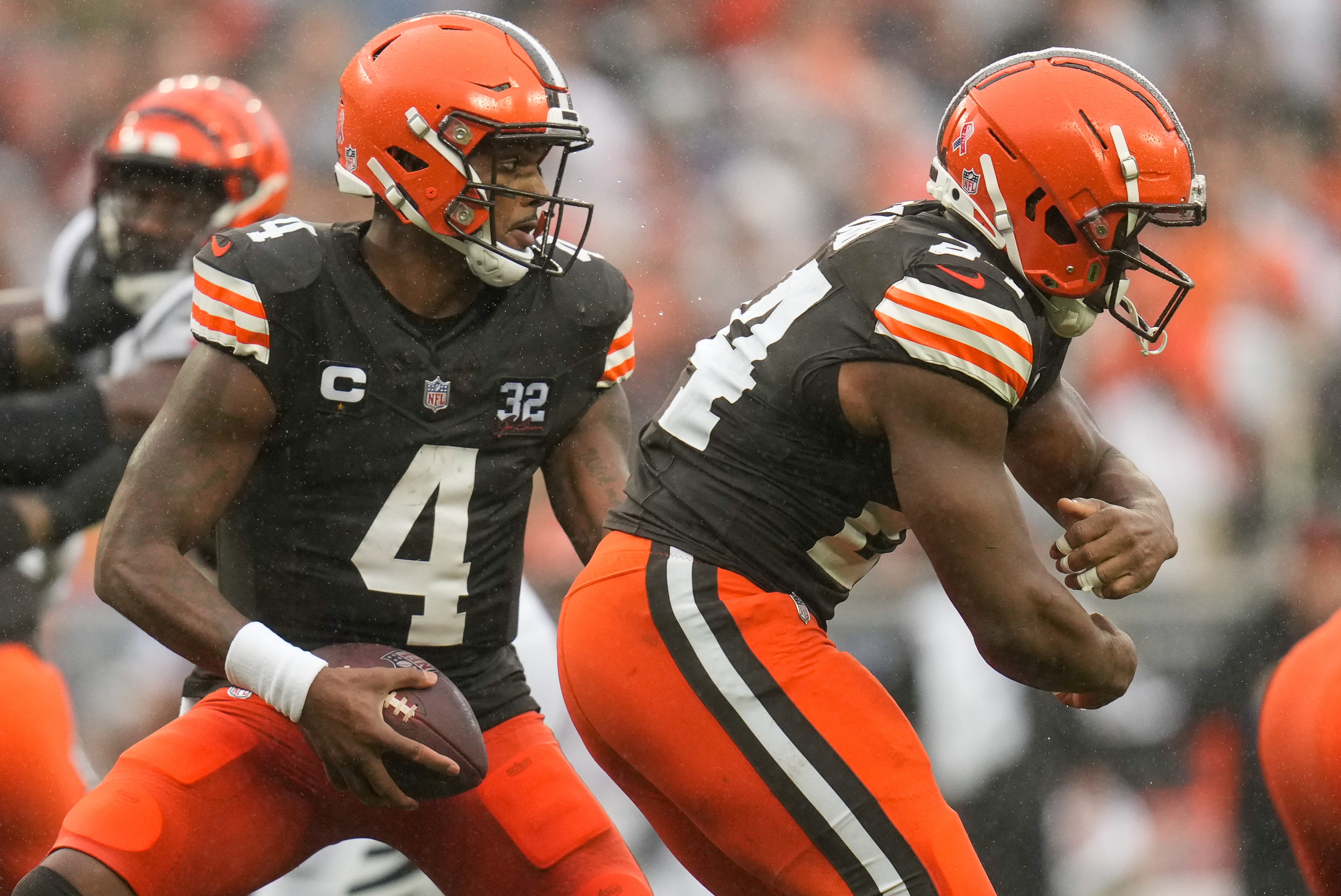 Cleveland Browns quarterback Deshaun Watson (4) fakes a handoff to running back Nick Chubb (24) in the second quarter of the NFL Week 1 game between the Cleveland Browns and the Cincinnati Bengals at FirstEnergy Stadium in downtown Cleveland on Sunday, Sept. 10, 2023. The Browns led 10-0 at halftime.