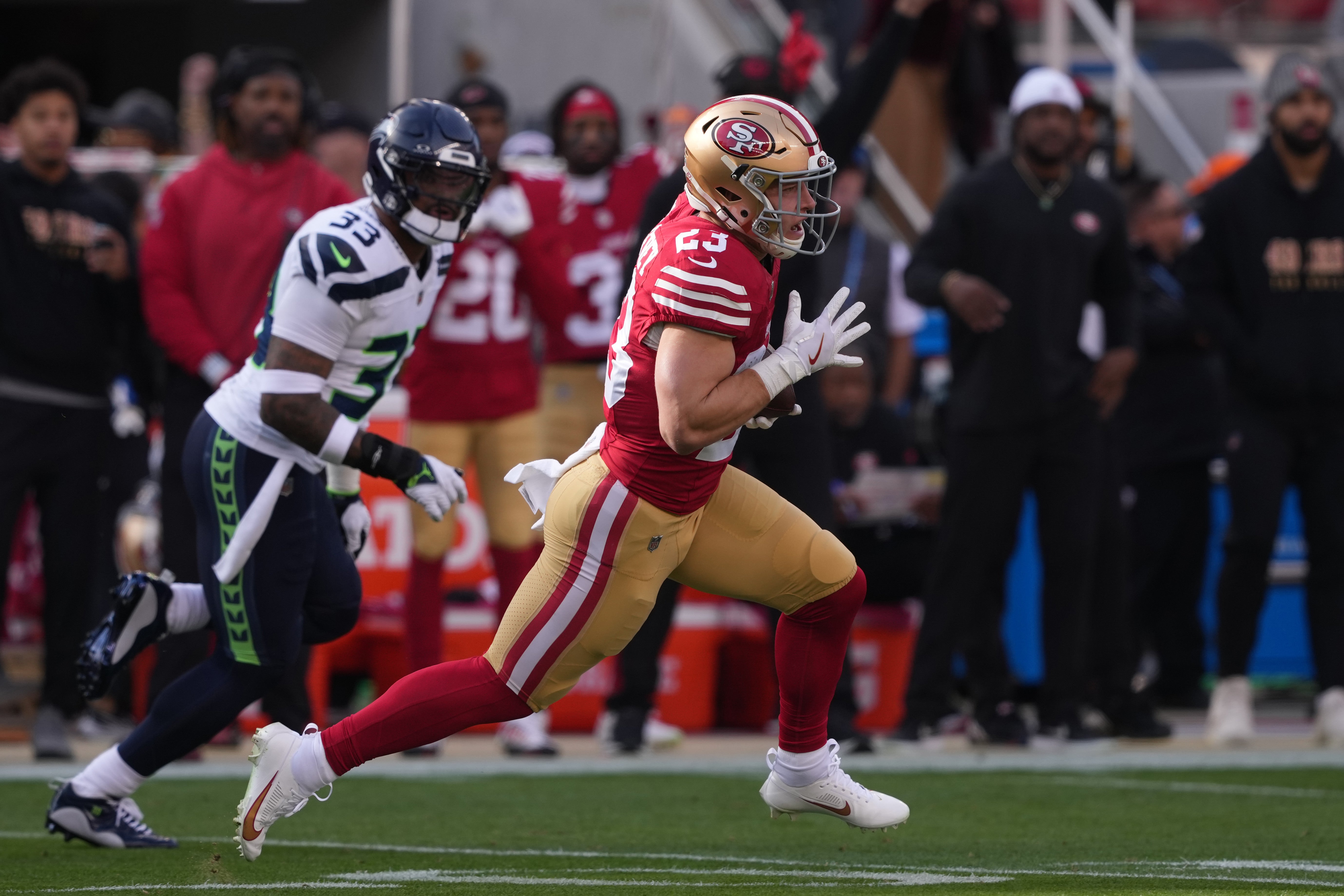 Dec 10, 2023; Santa Clara, California, USA; San Francisco 49ers running back Christian McCaffrey (23) carries the ball against Seattle Seahawks safety Jamal Adams (33) during the first quarter at Levi's Stadium.