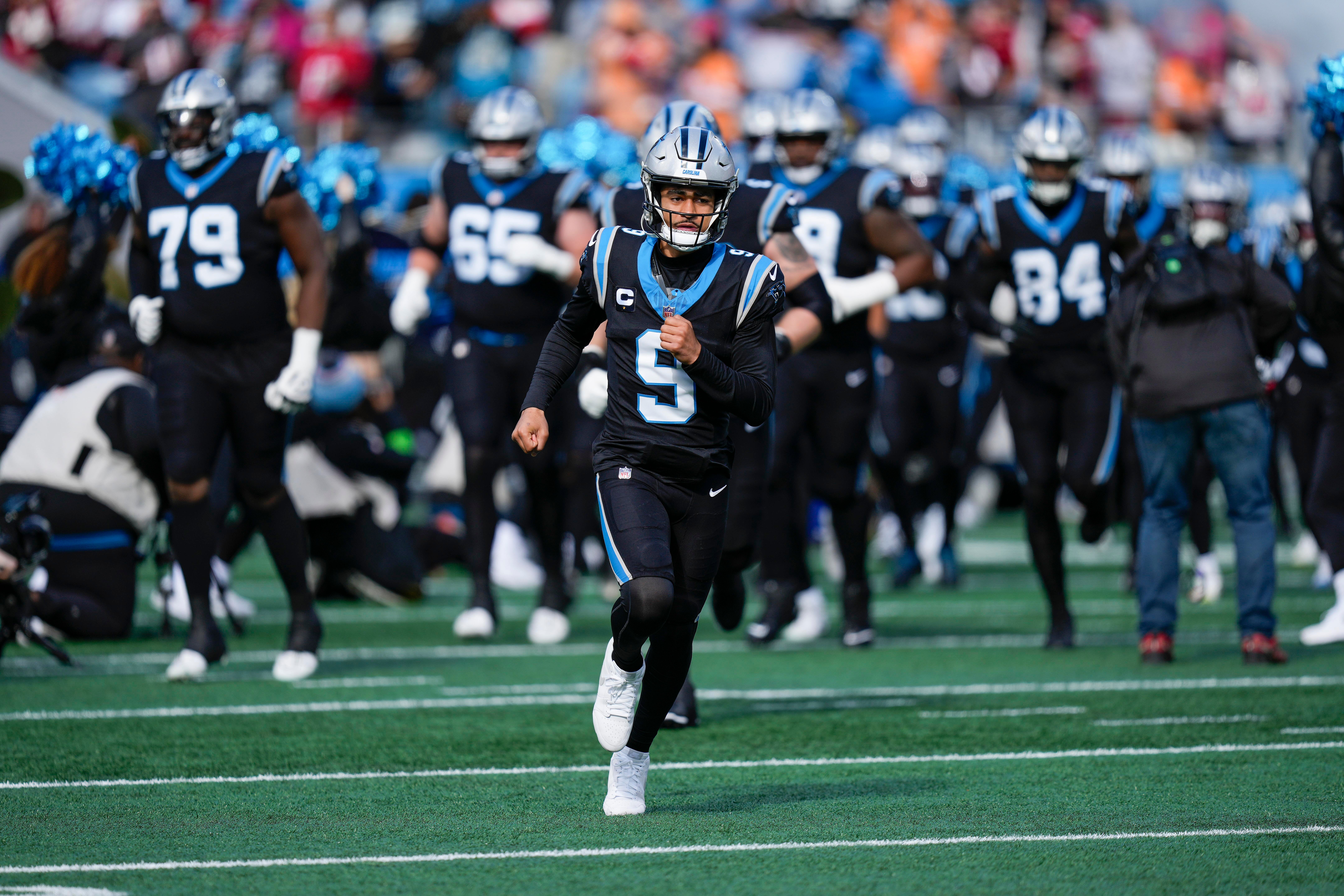 Jan 7, 2024; Charlotte, North Carolina, USA; Carolina Panthers quarterback Bryce Young (9) leads his team onto the field during the first quarter against the Tampa Bay Buccaneers at Bank of America Stadium. Mandatory Credit: Jim Dedmon-USA TODAY Sports