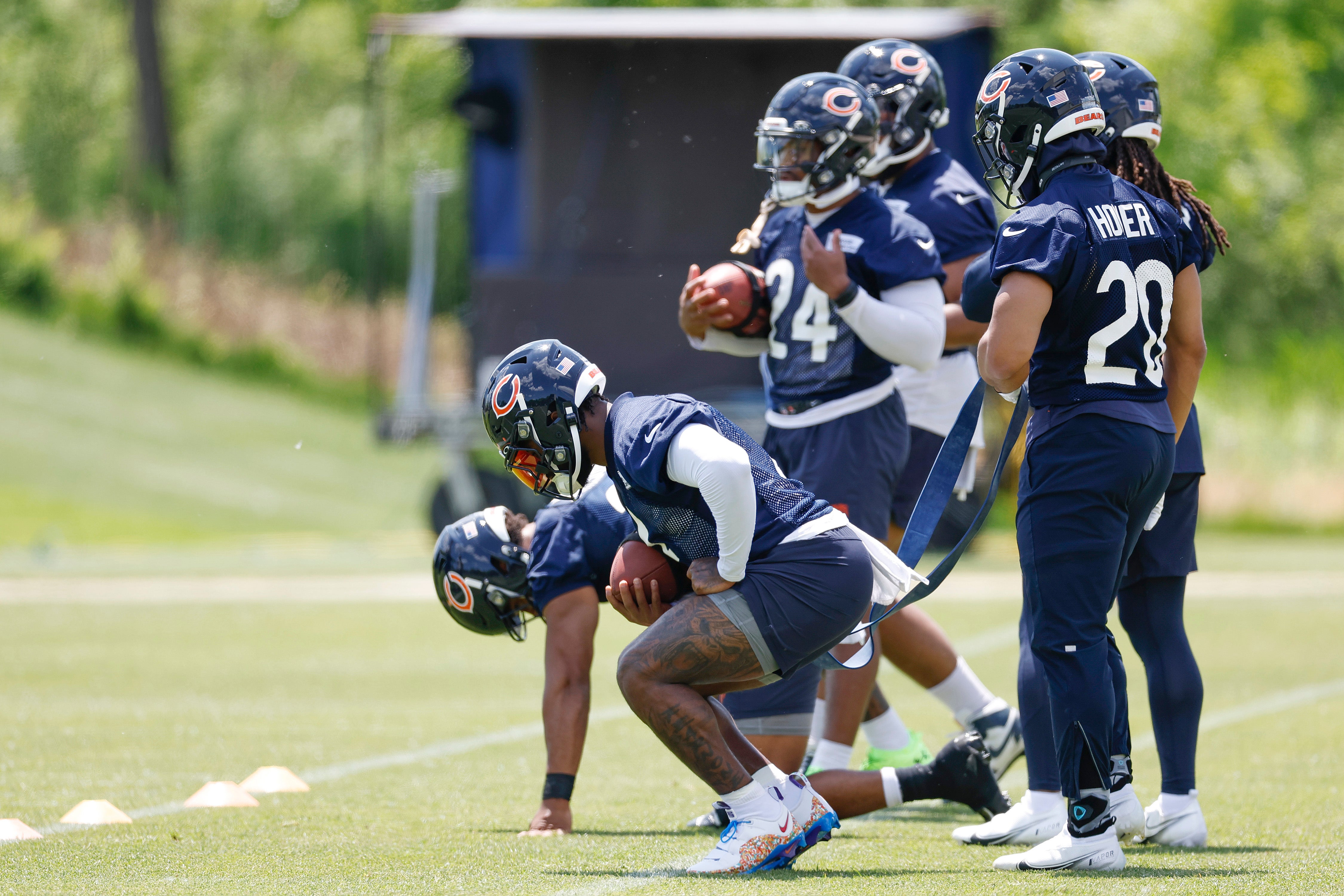 May 23, 2024; Lake Forest, IL, USA; Chicago Bears running backs warm up during organized team activities at Halas Hall.