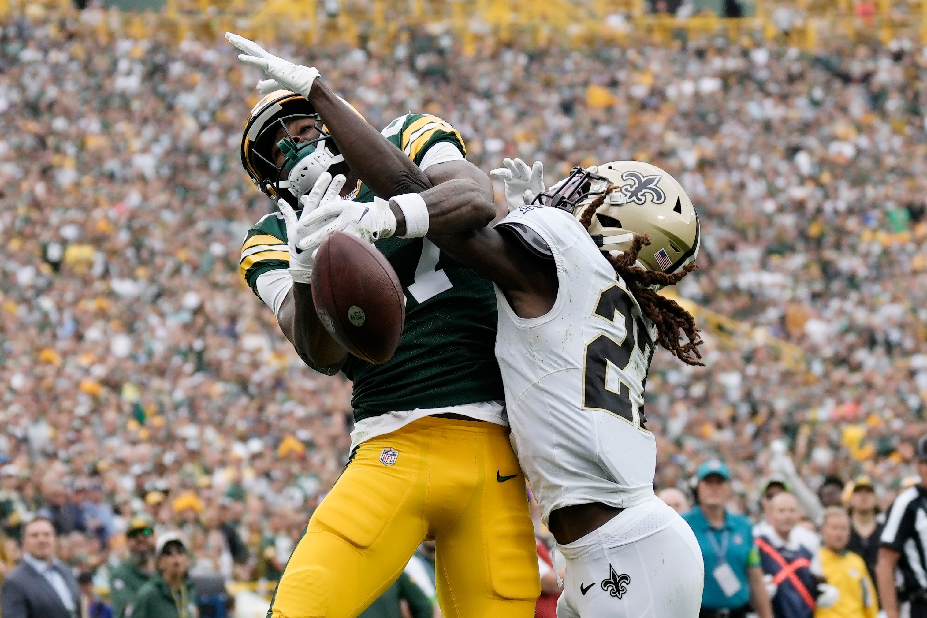 Sep 24, 2023; Green Bay, Wisconsin, USA; New Orleans Saints cornerback Isaac Yiadom (27) breaks up the pass intended for Green Bay Packers wide receiver Romeo Doubs (87) during the fourth quarter at Lambeau Field.