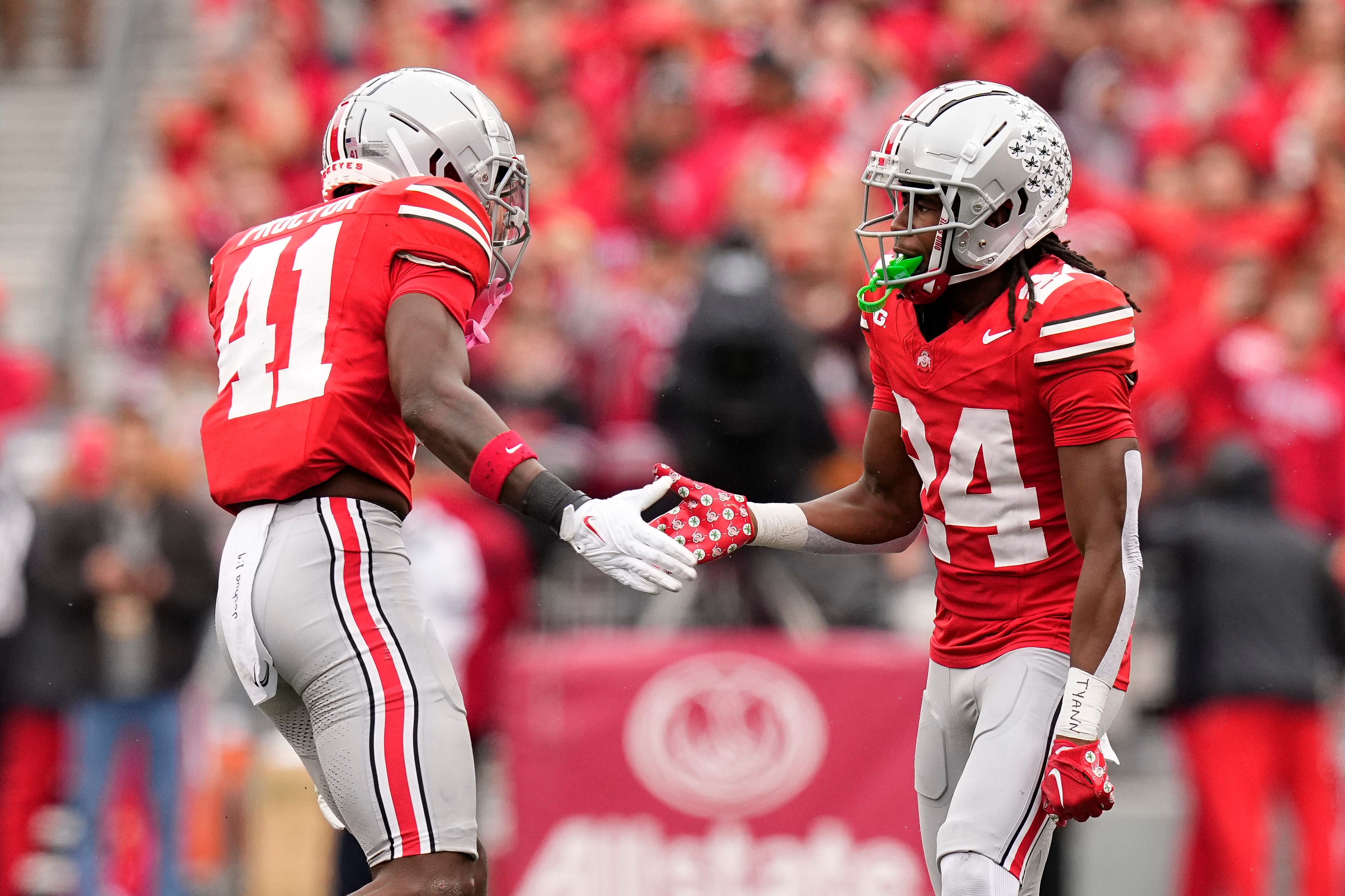 Oct 21, 2023; Columbus, Ohio, USA; Ohio State Buckeyes safety Josh Proctor (41) high fives cornerback Jermaine Mathews Jr. (24) after a defensive stop during the second half of the NCAA football game against the Penn State Nittany Lions at Ohio Stadium. Ohio State won 20-12.