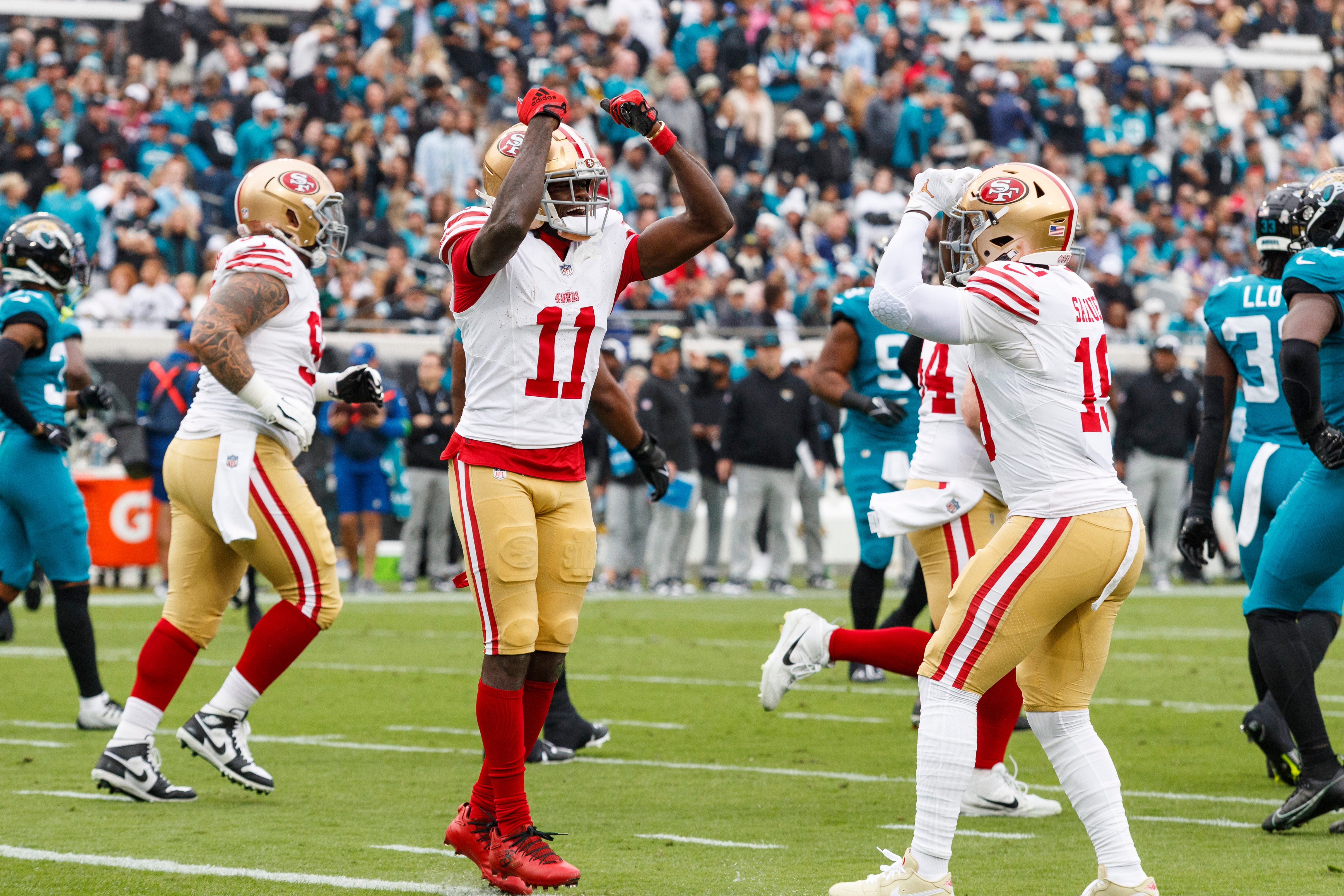 Nov 12, 2023; Jacksonville, Florida, USA; San Francisco 49ers wide receiver Brandon Aiyuk (11) and wide receiver Deebo Samuel (19) celebrate a touchdown against the Jacksonville Jaguars during the first quarter at EverBank Stadium.