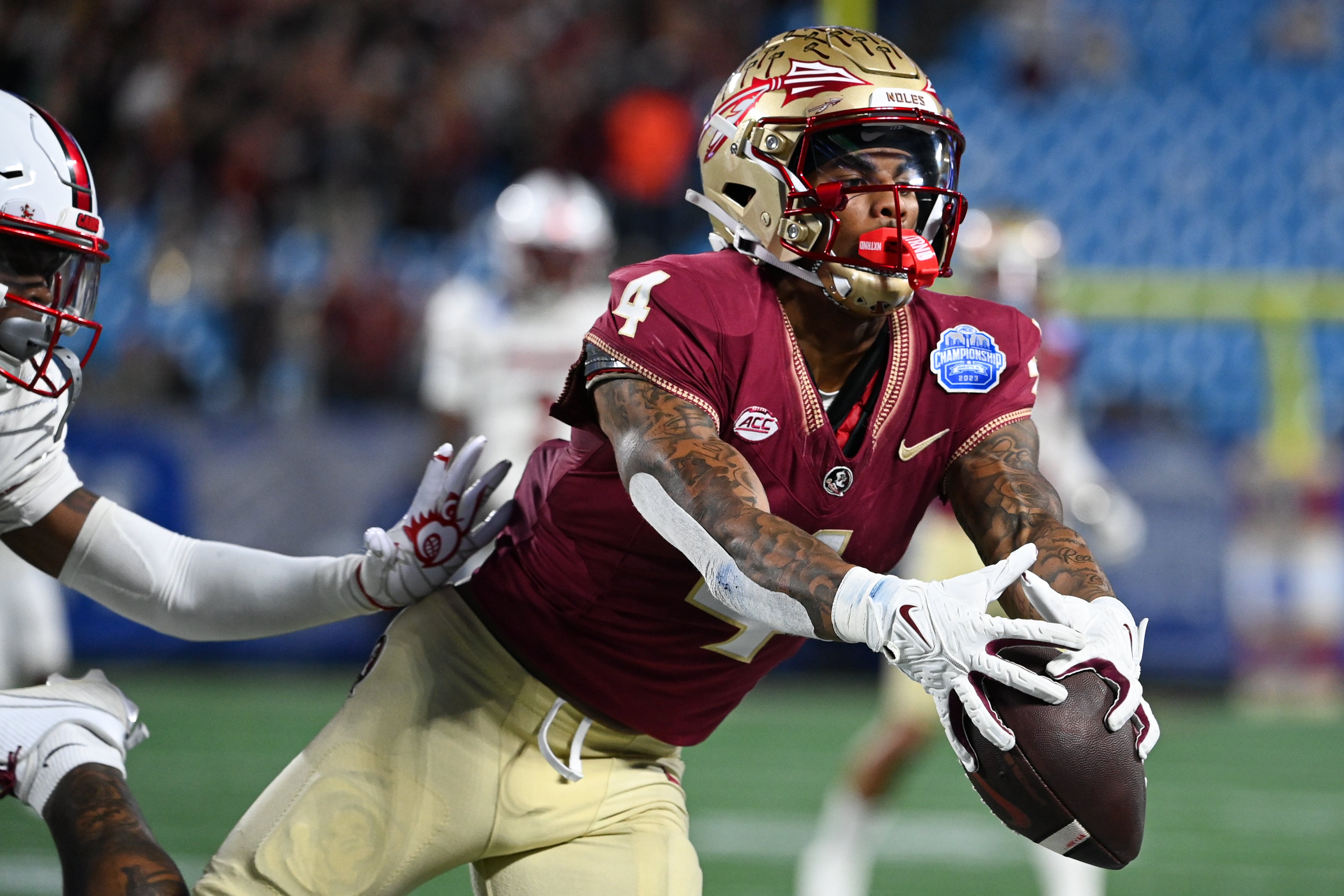Florida State Seminoles wide receiver Keon Coleman (4) makes a catch against the Louisville Cardinals in the second quarter at Bank of America Stadium.