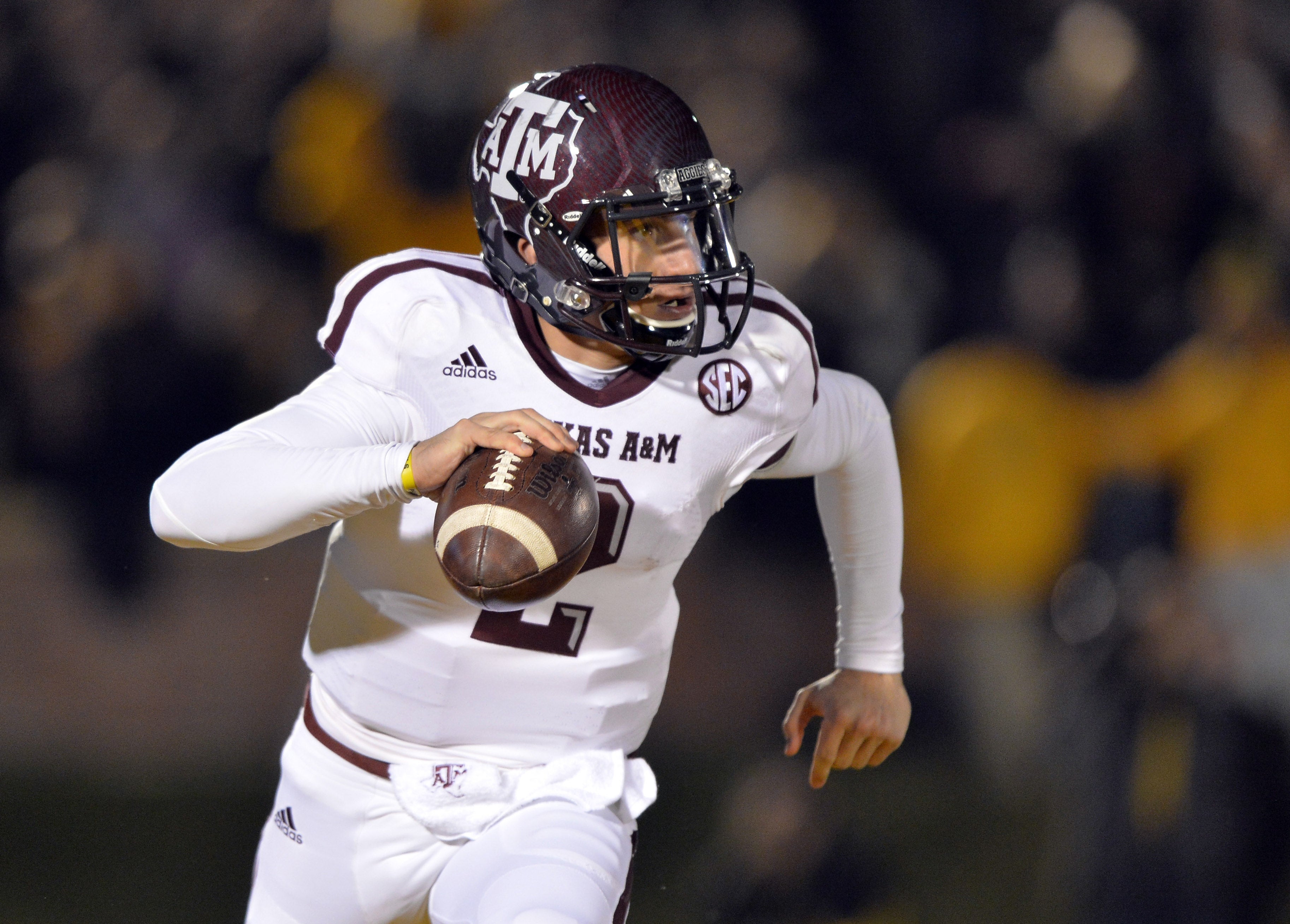 Texas A&M Aggies quarterback Johnny Manziel (2) scrambles to the outside against the Missouri Tigers during the first half at Faurot Field.