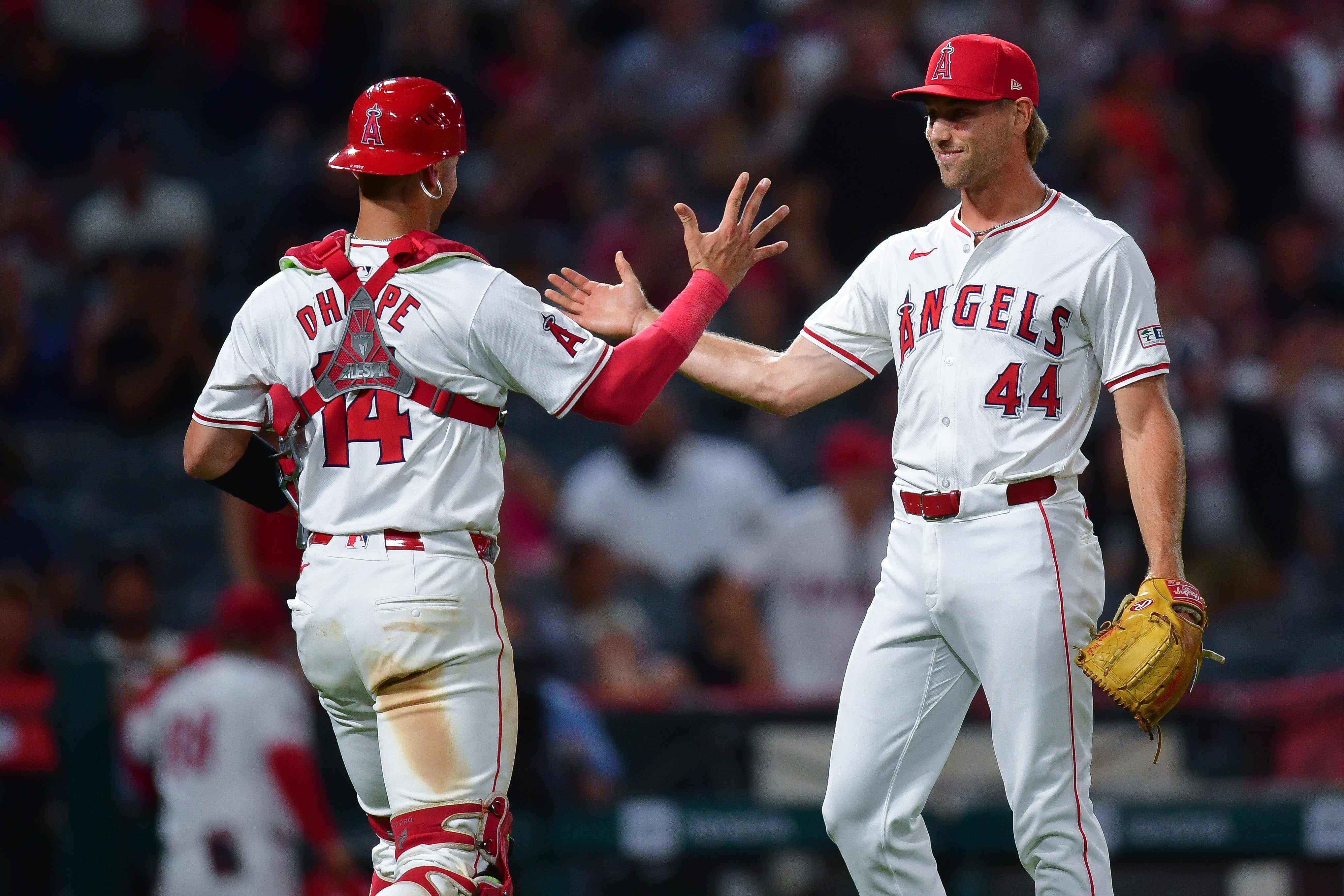 Jun 27, 2024; Anaheim, California, USA; Los Angeles Angels catcher Logan O'Hoppe (14) and pitcher Ben Joyce (44) celebrate the victory against the Detroit Tigers at Angel Stadium.