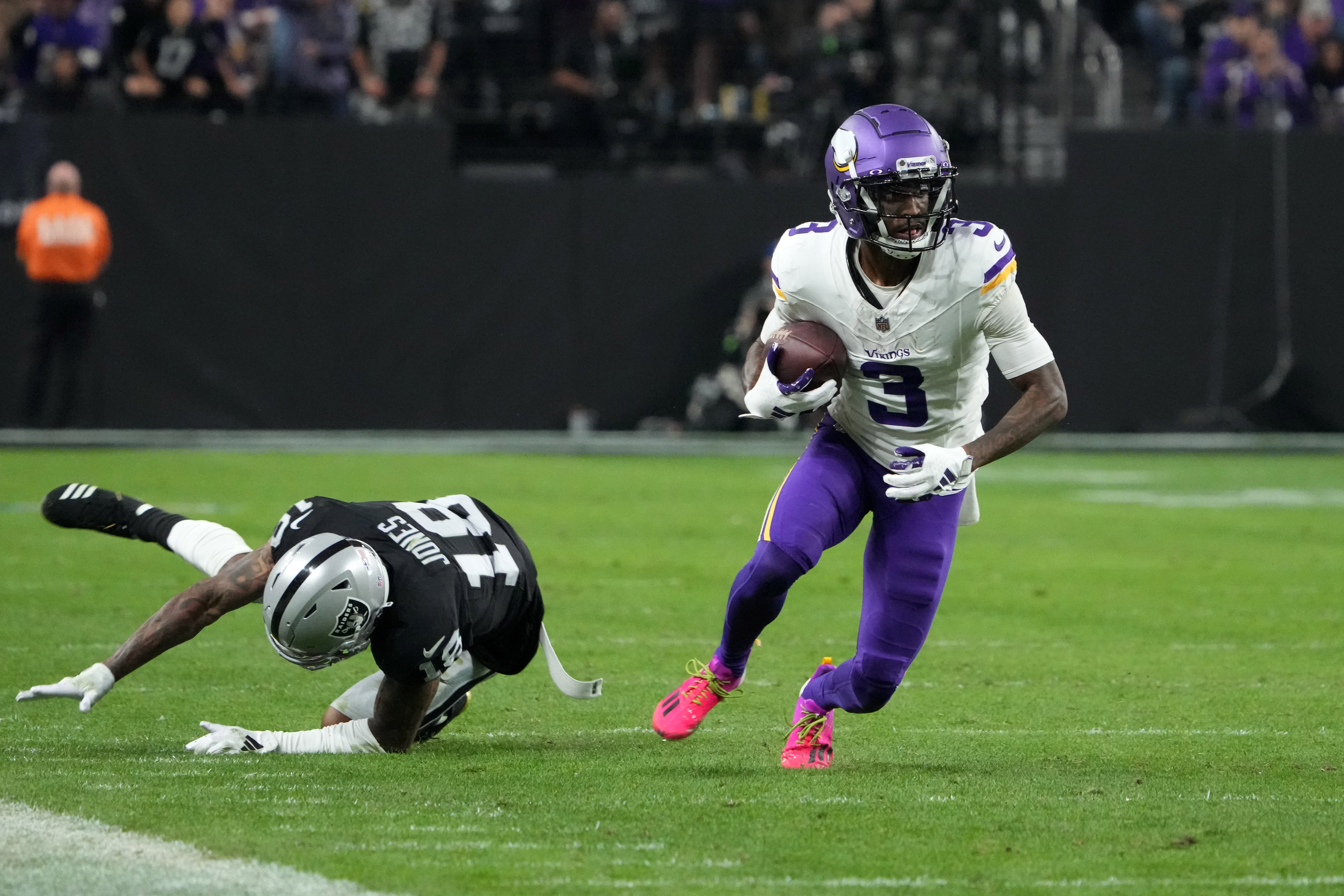 Dec 10, 2023; Paradise, Nevada, USA; Minnesota Vikings wide receiver Jordan Addison (3) carries the ball against Las Vegas Raiders cornerback Jack Jones (18) in the second half at Allegiant Stadium. Mandatory Credit: Kirby Lee-USA TODAY Sports
