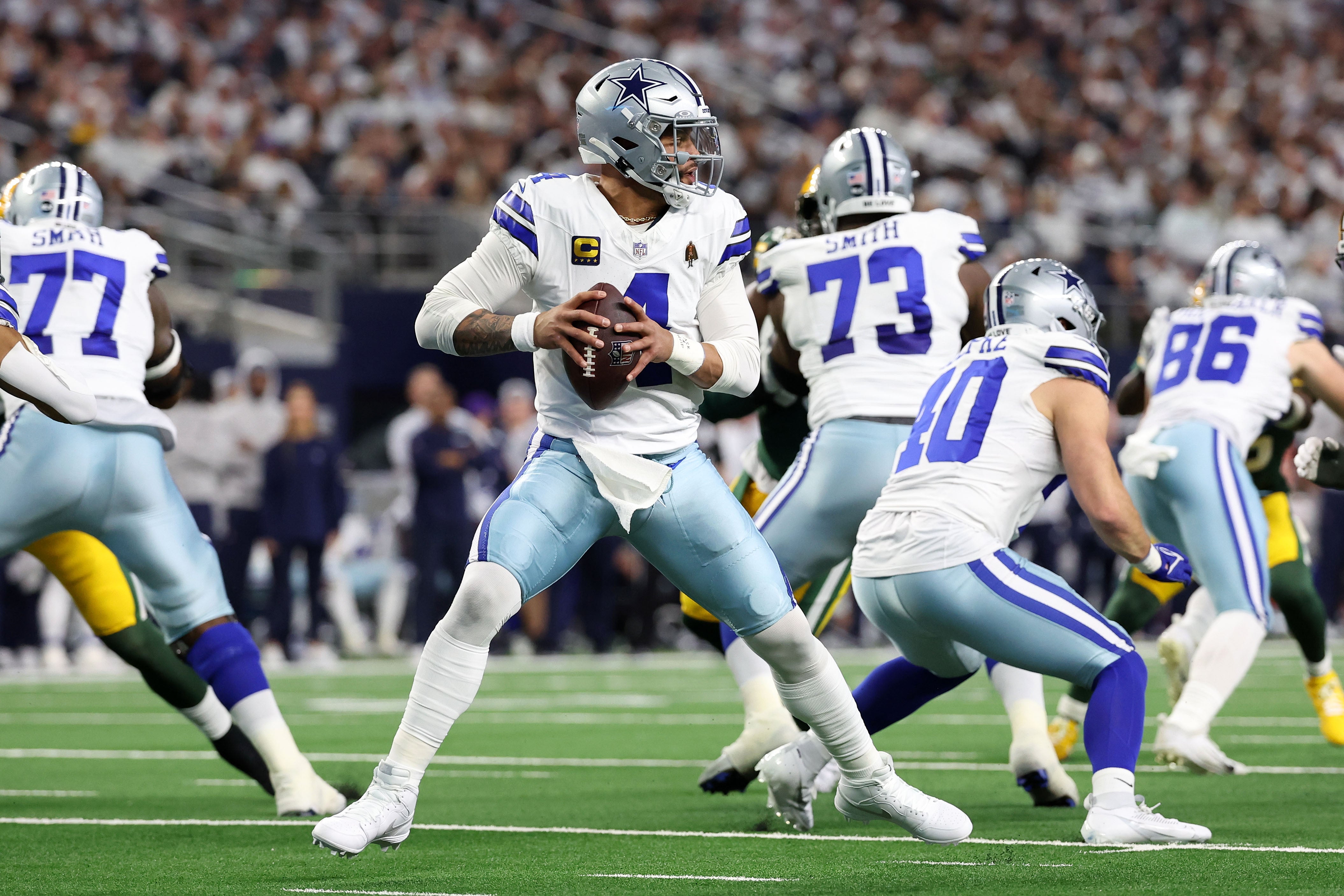 Dallas Cowboys quarterback Dak Prescott (4) drops back to pass against the Green Bay Packers in the first half of the 2024 NFC wild card game at AT&T Stadium.