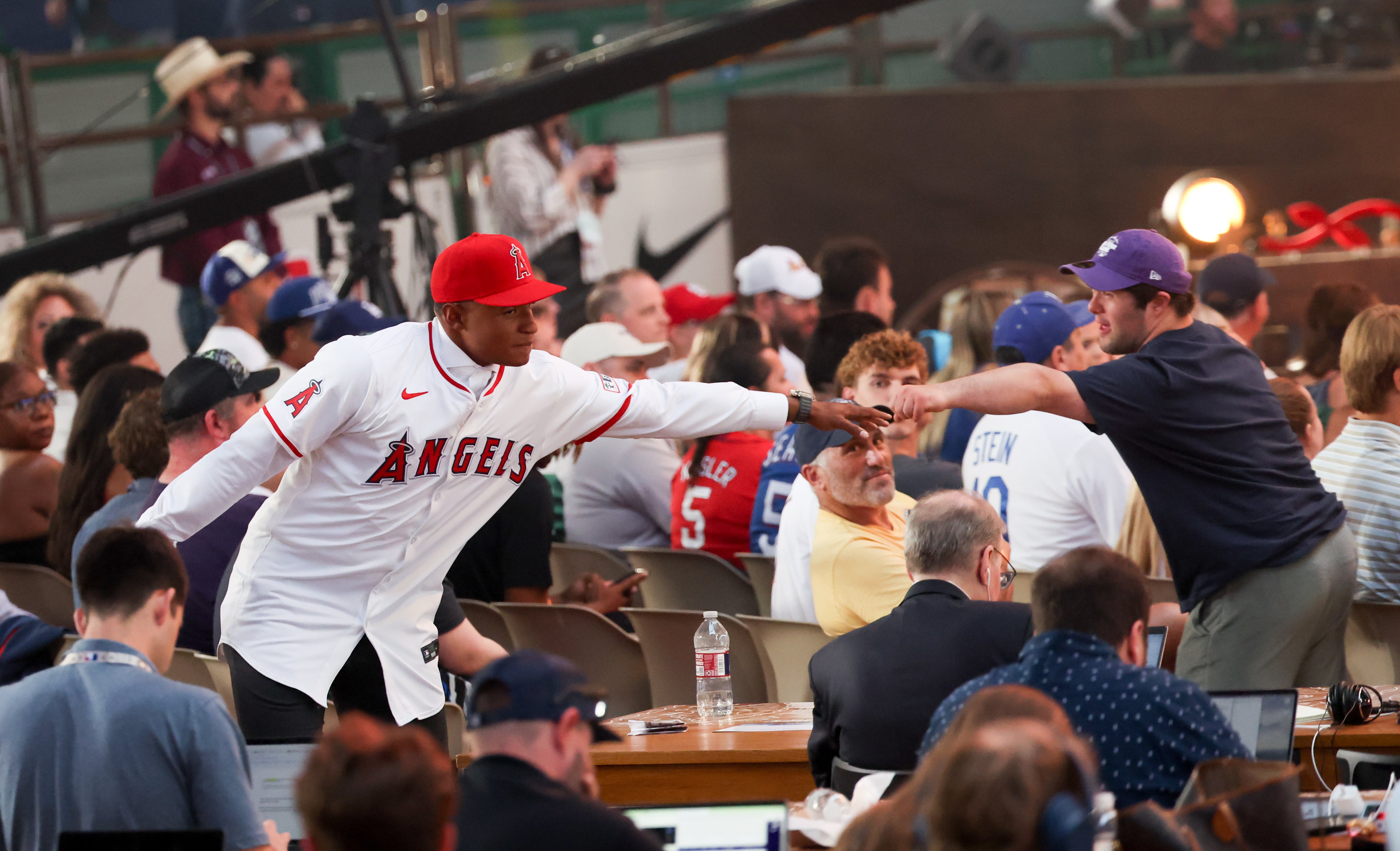 Jul 14, 2024; Ft. Worth, TX, USA; Christian Moore celebrates with fans after being selected by the Los Angeles Angels as the eight player taken during the first round of the MLB Draft at Cowtown Coliseum.