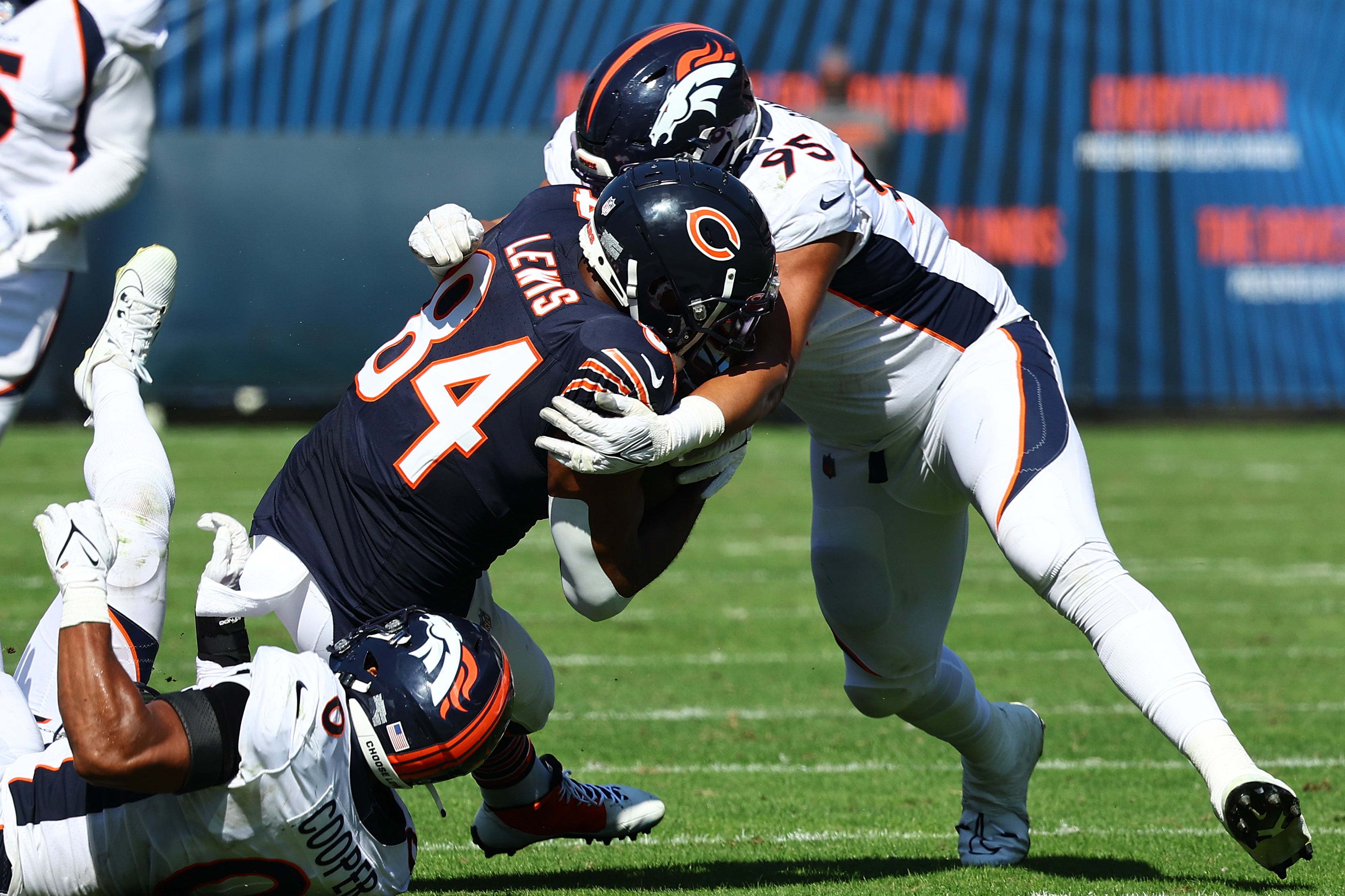 Oct 1, 2023; Chicago, Illinois, USA; Denver Broncos defensive tackle Elijah Garcia (95) tackles Chicago Bears tight end Marcedes Lewis (84) during the second half at Soldier Field.