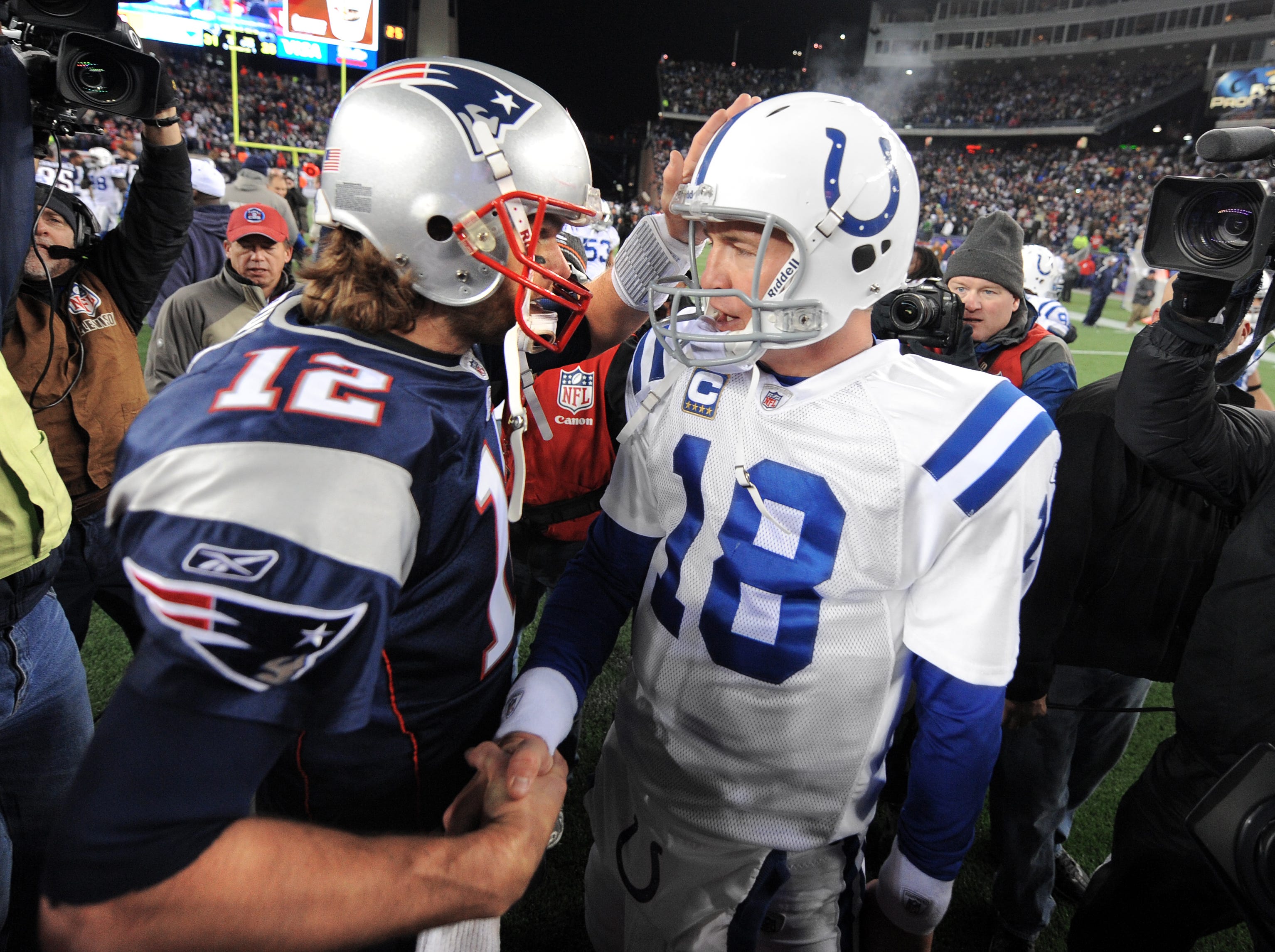 Indianapolis Colts quarterback Peyton Manning, right, meets with New England Patriots quarterback Tom Brady after a game at Gillette Stadium on Nov. 21, 2010. The Colts lost 31-28.