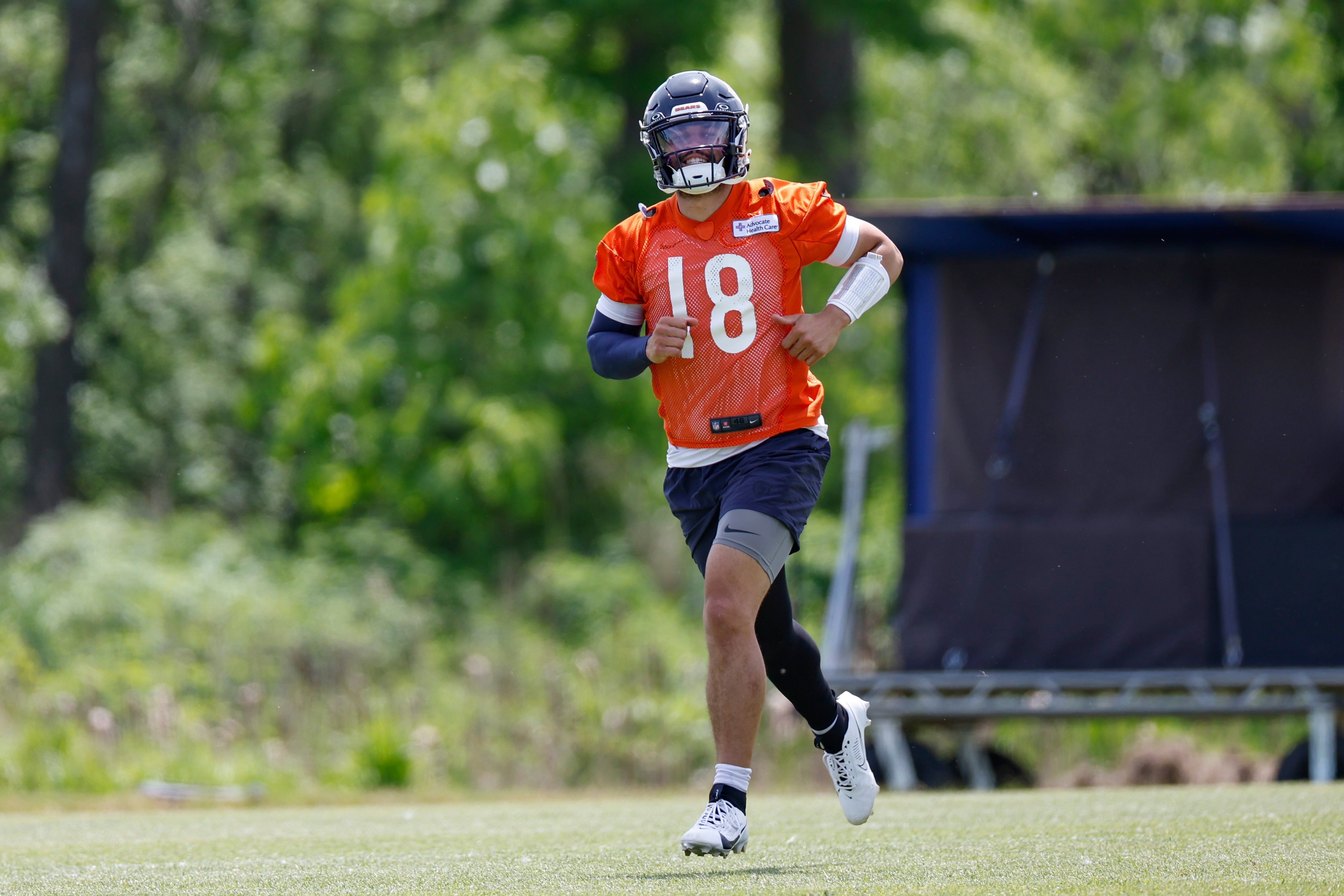 May 31, 2024; Lake Forest, IL, USA; Chicago Bears quarterback Caleb Williams (18) runs on the field during organized team activities at Halas Hall.