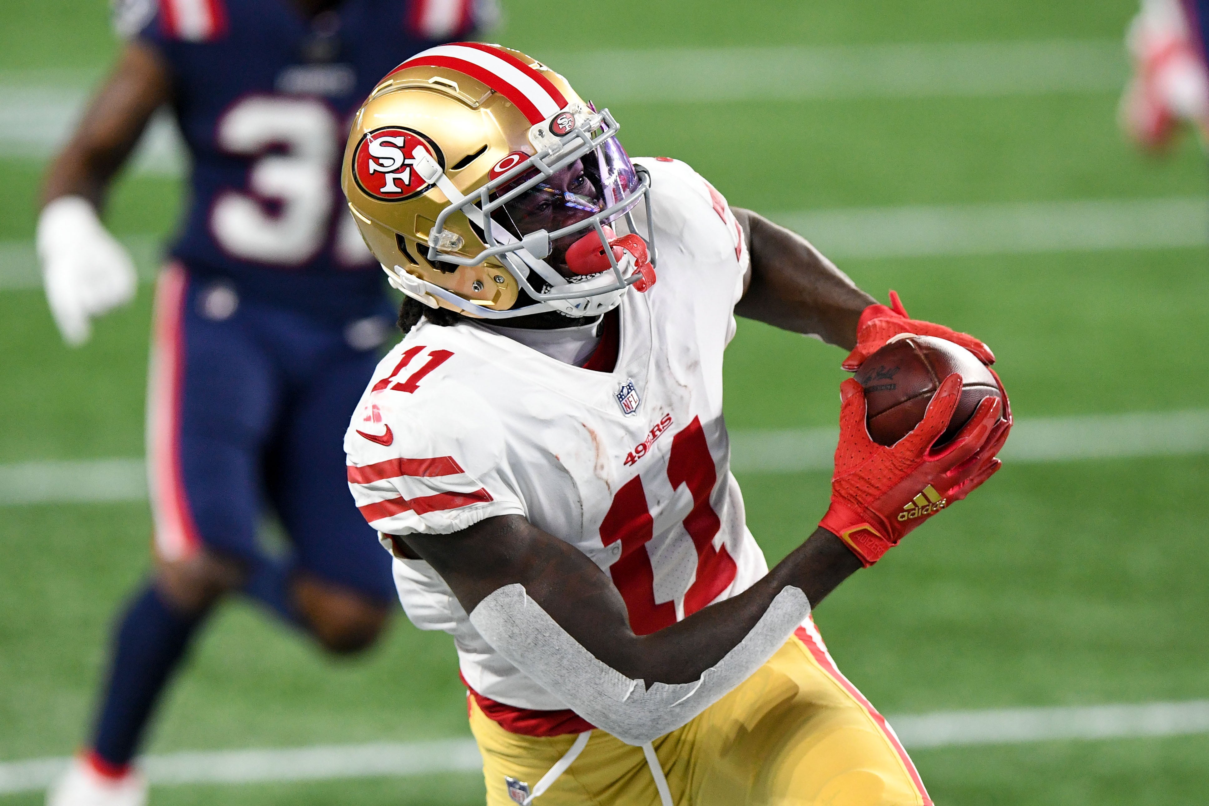 Oct 25, 2020; Foxborough, Massachusetts, USA; San Francisco 49ers wide receiver Brandon Aiyuk (11) makes a catch on a pass from quarterback Jimmy Garoppolo (not seen) during the second half against the New England Patriots at Gillette Stadium.