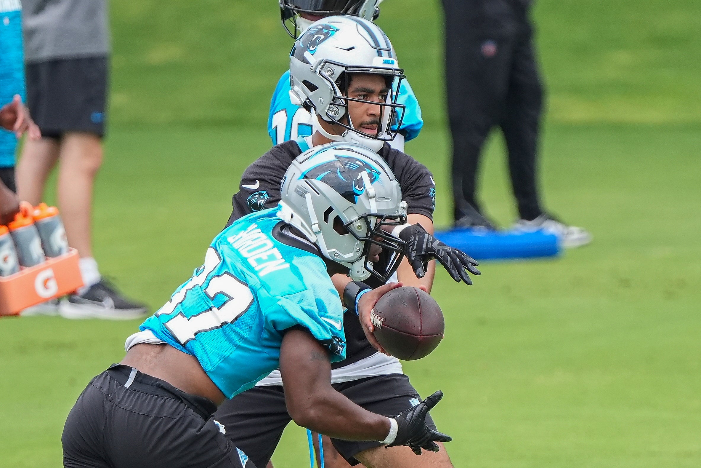 Jun 4, 2024; Charlotte, NC, USA; Carolina Panthers quarterback Bryce Young (9) hands off to running back Jaden Shirden (37) during OTAs. Mandatory Credit: Jim Dedmon-USA TODAY Sports